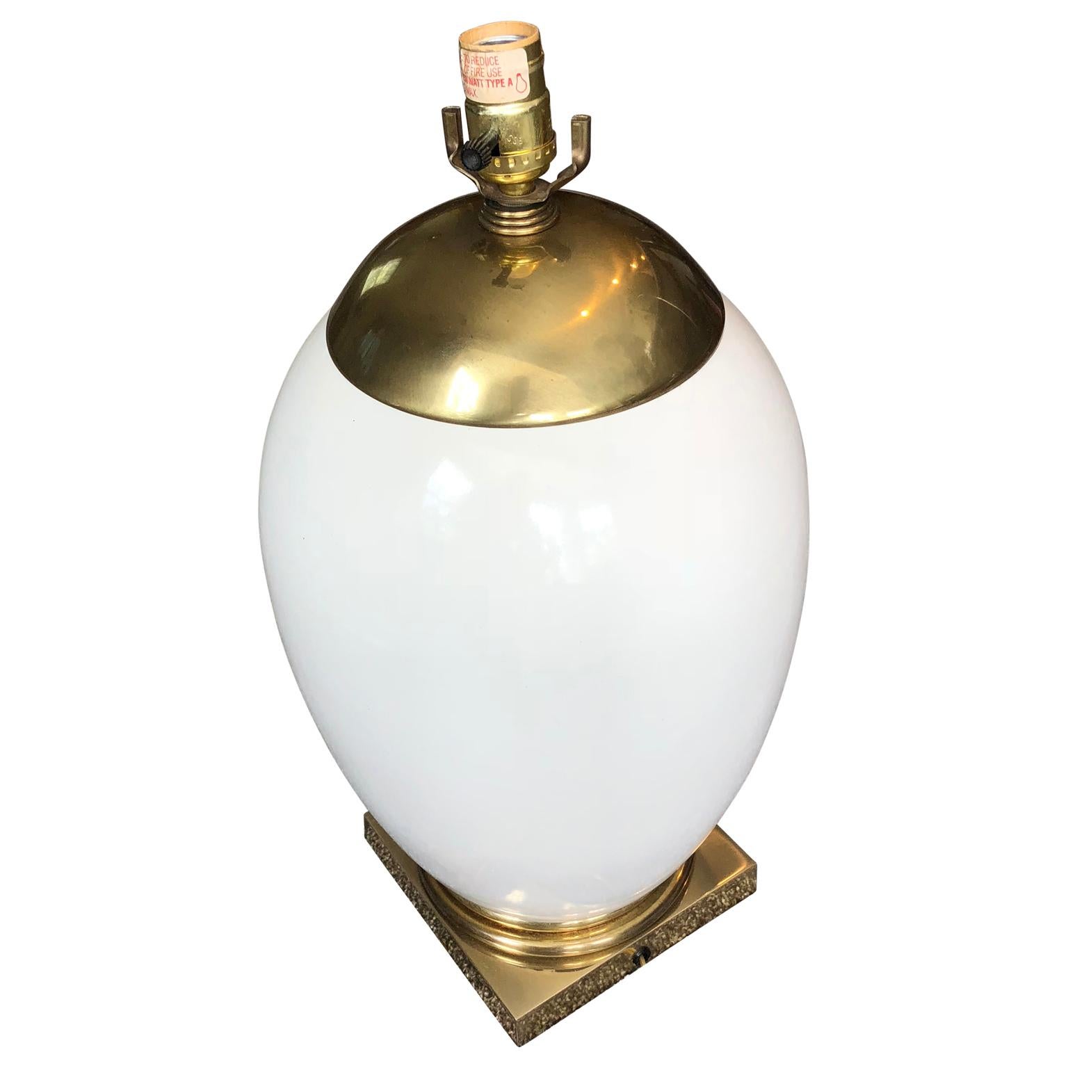 Mid-Century Modern Ellipse shaped enamel and brass table lamp. Lamp is newly re-wired. This large lamp is timeless in it's design; it easily fits into any decor style in any room of your home. The solid white body is accented with brass top and