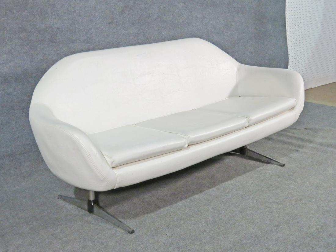 With a modern design and a comfortable cushioned surface, this vintage sofa is sleek and stylish. Please confirm item location with seller (NY/NJ).