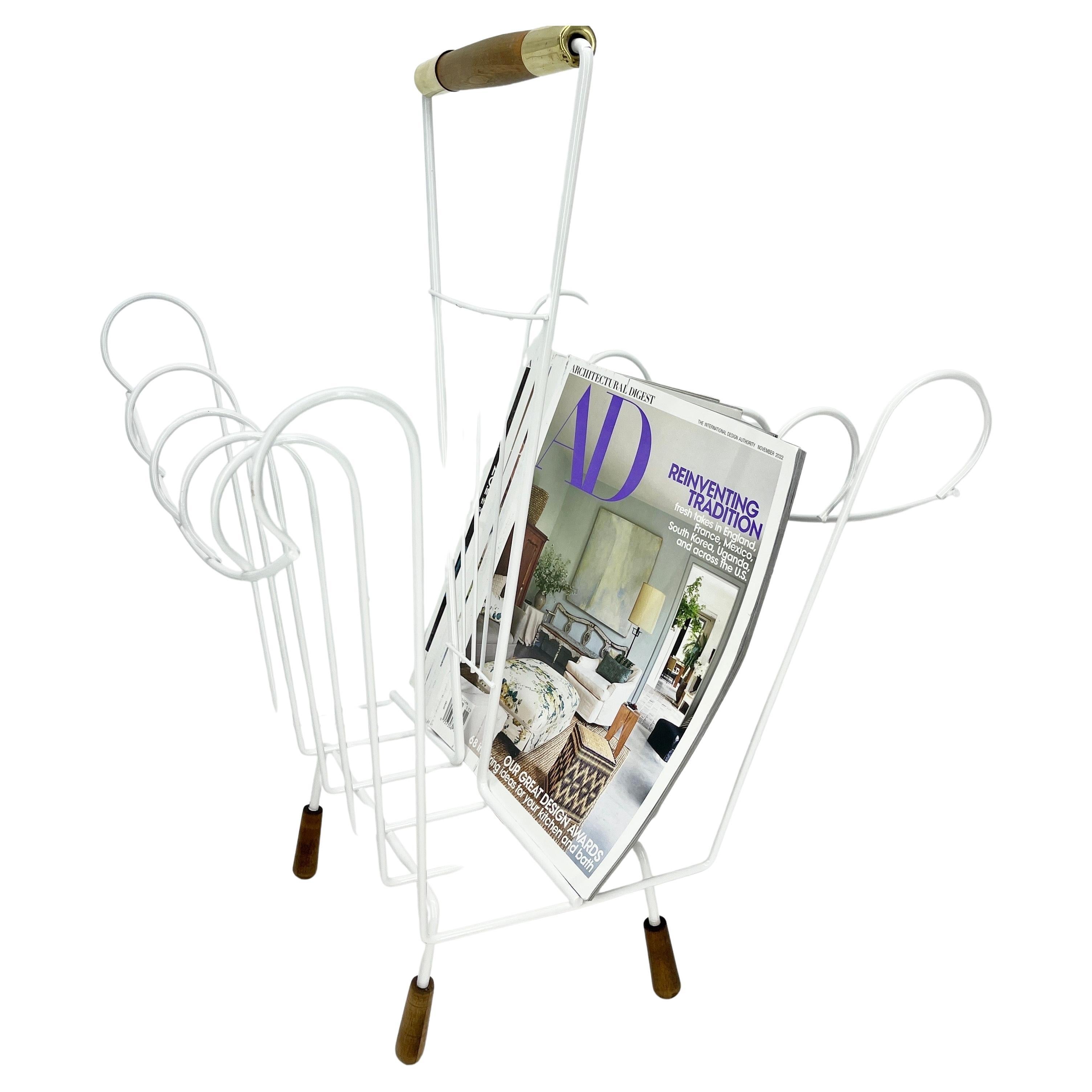 White powder-coated 1960s Arthur Umanoff sculptural metal magazine rack with wooden and brass hardware.