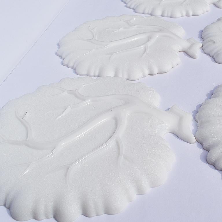 Set of 5 vintage milk glass dessert plates in the shape of a cabbage. Each plate is formed in the shape of cabbage or head of lettuce, with the stem at the top, and scalloped edges. At the bottom are protruding lines that resemble the cabbage leaves