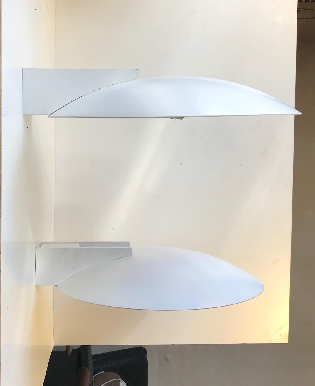 A pair of fixed wall lights designed and manufactured by Pierre Disderot Paris during the 1980s. These are up light sconces that projects the light towards the ceiling creating an ambient and cosy lighting in the room. They can easily be used as