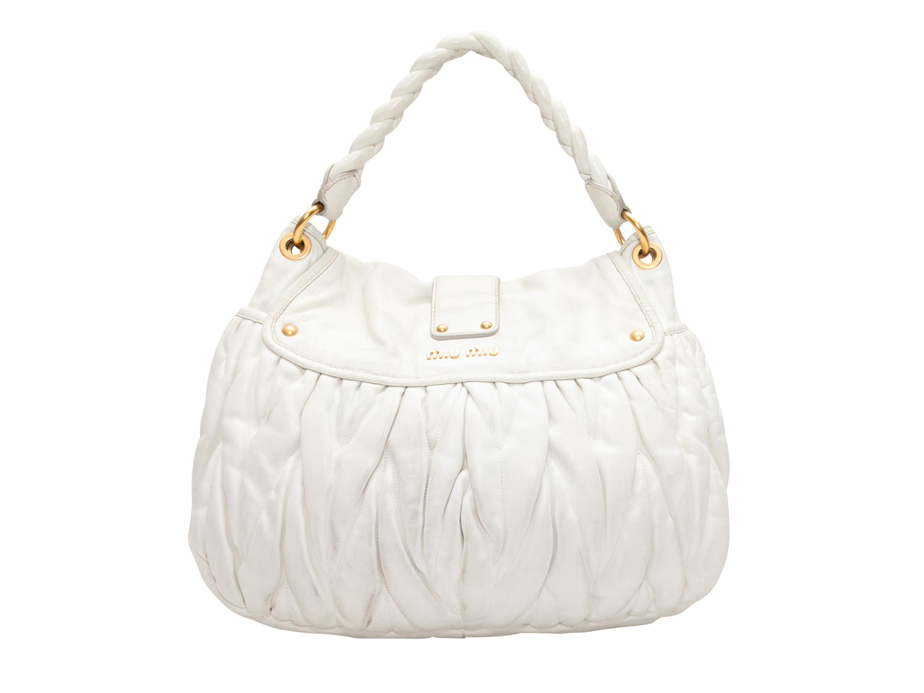 White Miu Miu Matelasse Shoulder Bag. This shoulder bag features a leather body, gold-tone hardware, a single braided shoulder strap, and a front push-lock closure. 15