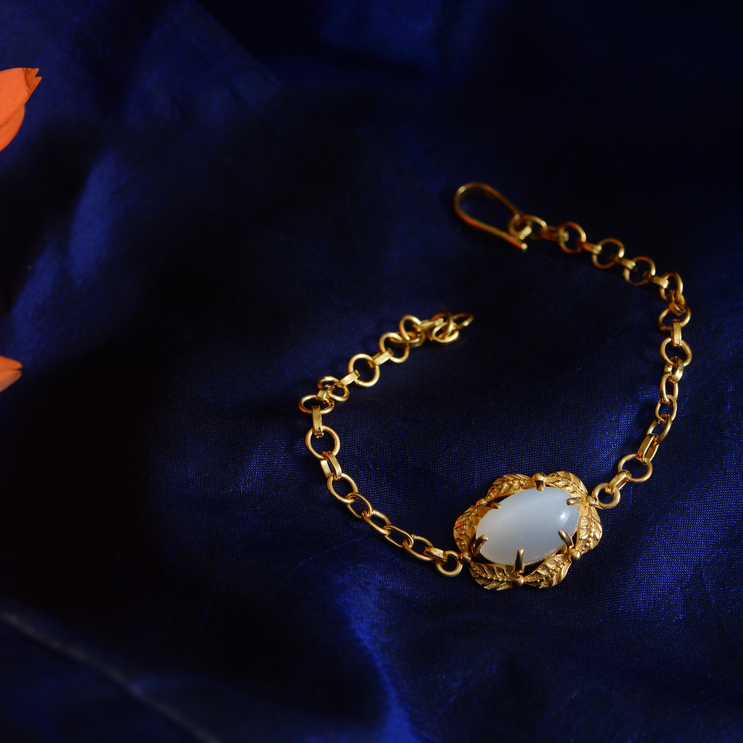 This lovely moonstone bracelet has been handmade in our workshops. It is embedded with a white moonstone and set in exquisite hand engraving work. The bracelet which is adjustable is made in sterling silver coated in 24k gold plate.

It has matching