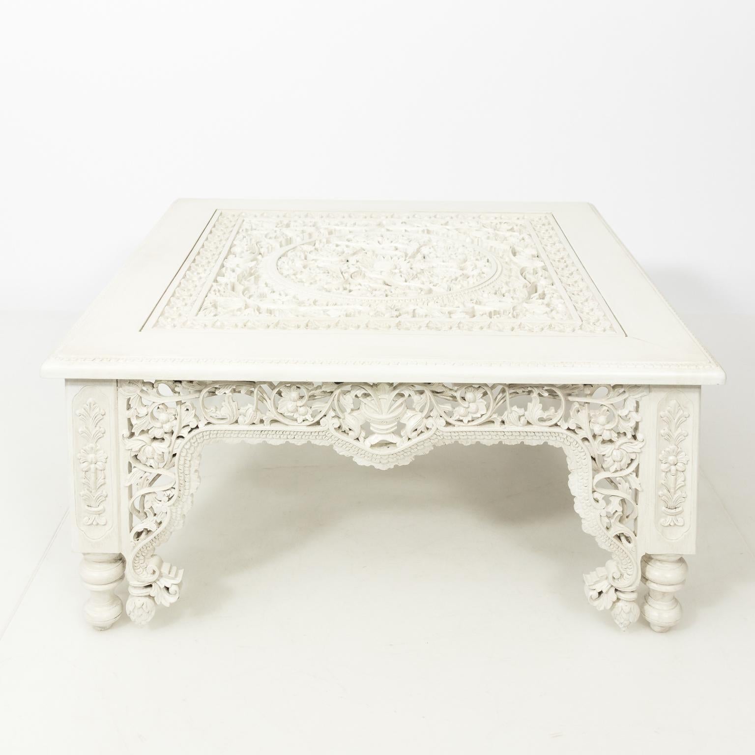 White painted Moroccan coffee table with heavily carved Arabesque style floral tracery throughout, circa 20th century.
 