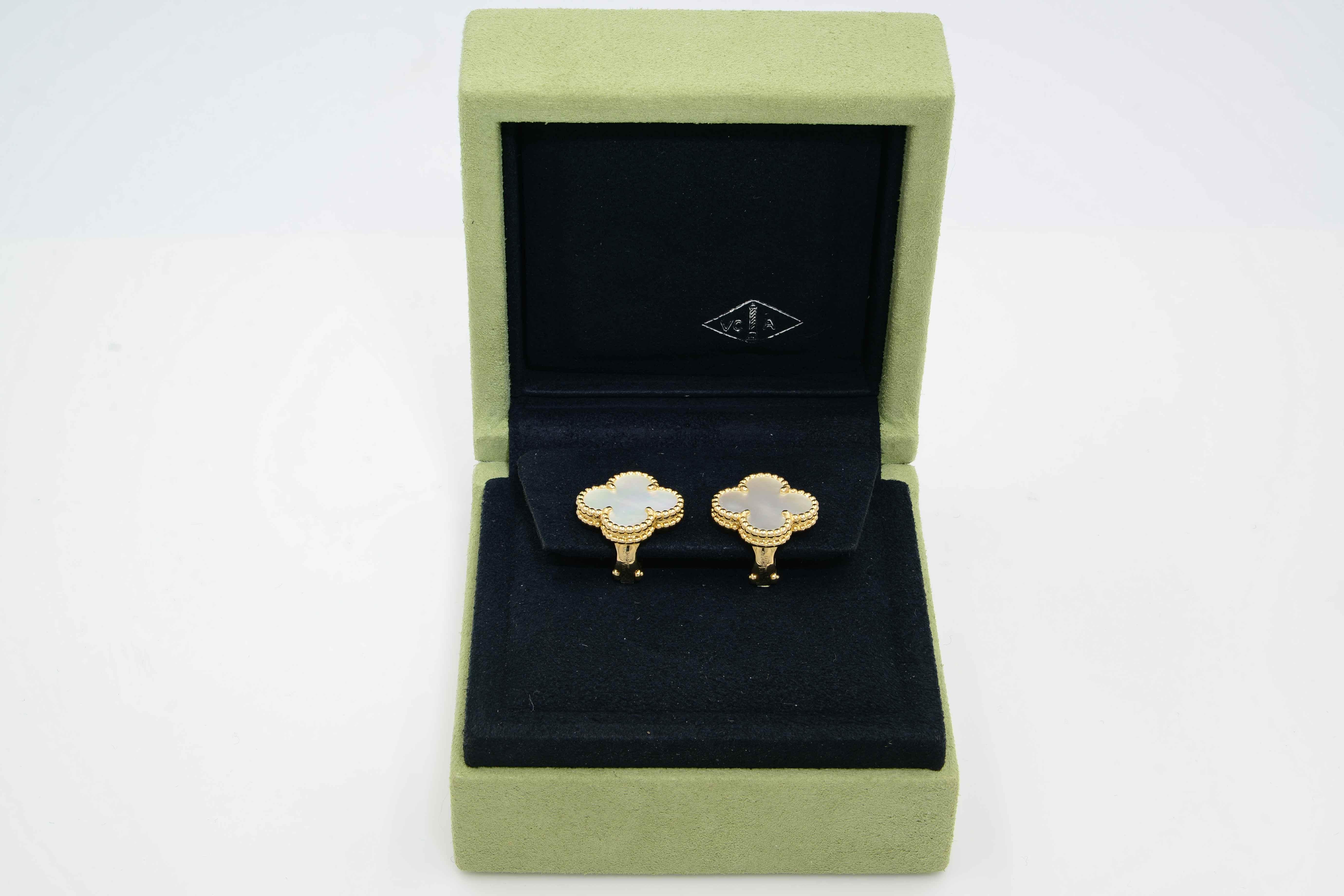 A single clover motif adorns Van Cleef & Arpels' Vintage Alhambra Earrings! White mother of pearl is edged in a double row of 18K yellow gold beading in these pierced earrings with hallmarked omega-clip backings. 

They are in excellent condition