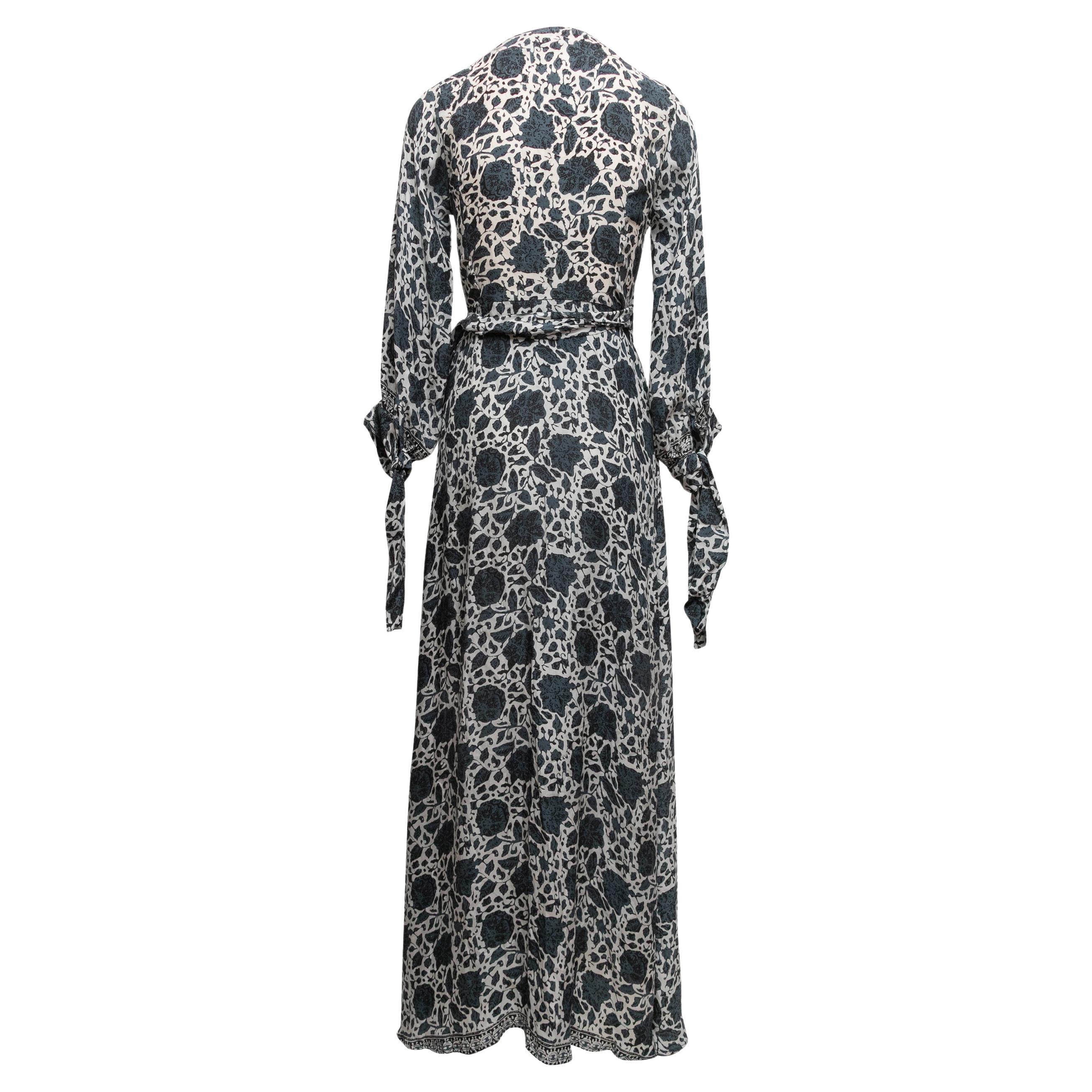 White and multicolor silk floral print maxi wrap dress by Natalie Martin. Surplice neckline. Long sleeves. Waist tie closure. 32