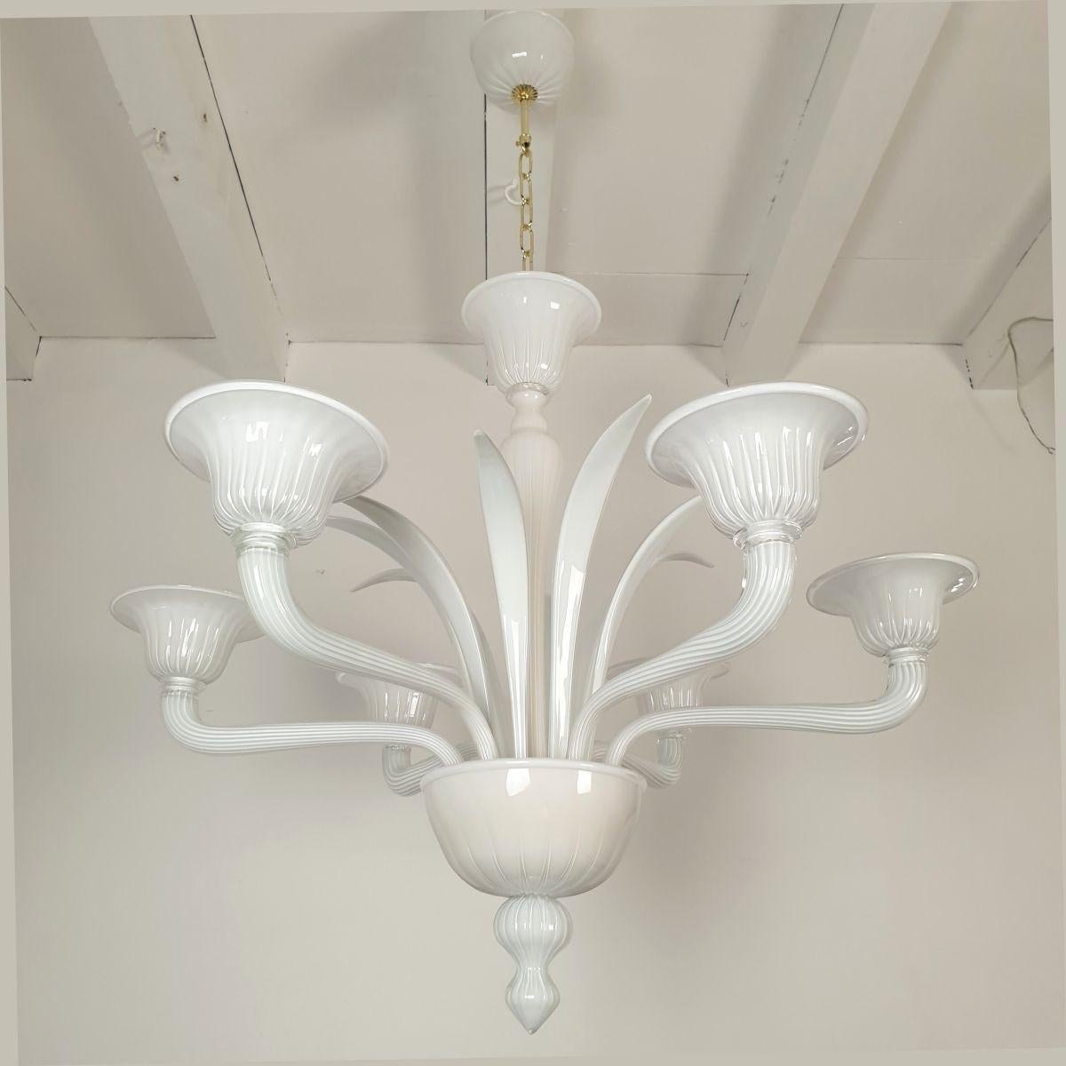 Large Mid Century Modern white Murano glass chandelier, attributed to Venini, Italy 1970s.
The neoclassical style chandelier is made of hand blown milk white Murano glass.
You can see a transparent layer of glass over the white color, which gives a