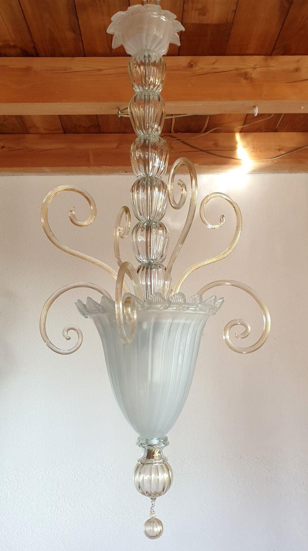 Tall Neoclassical Murano glass lantern or chandelier, attributed to Venini, Italy 1960s.
The Mid-Century Modern lantern is made of a frosted translucent Murano glass bottom vase, nesting 3 lights and clear and gold leaf ornaments.
The Italian