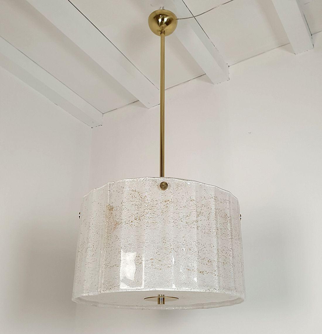 Large white Murano glass drum chandelier, attributed to Mazzega, Italy 1970s.
The Mid-Century Modern chandelier is made of white thick Murano glass, with real gold flakes.
The frame and central stem are in brass. The height of the central stem can