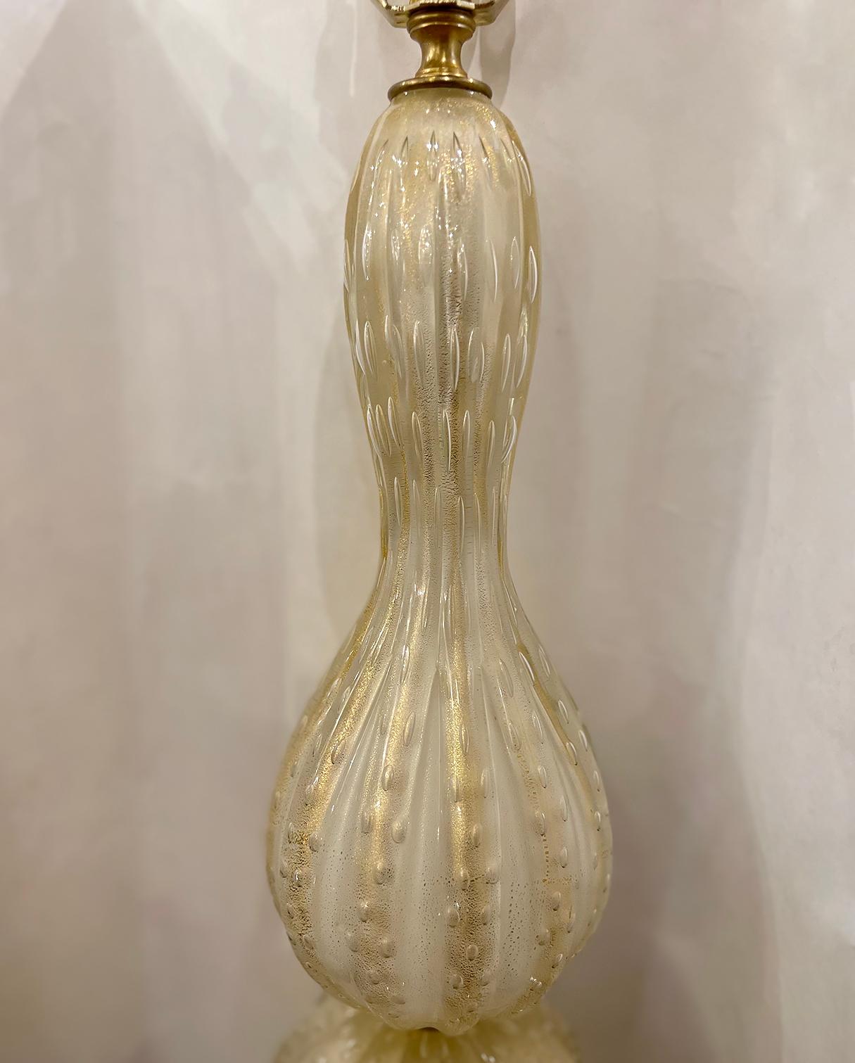 A single circa 1930s Italian blown Murano glass lamp with gold speckles in a white and clear body. 

Measurements:
Heigh of body: 21