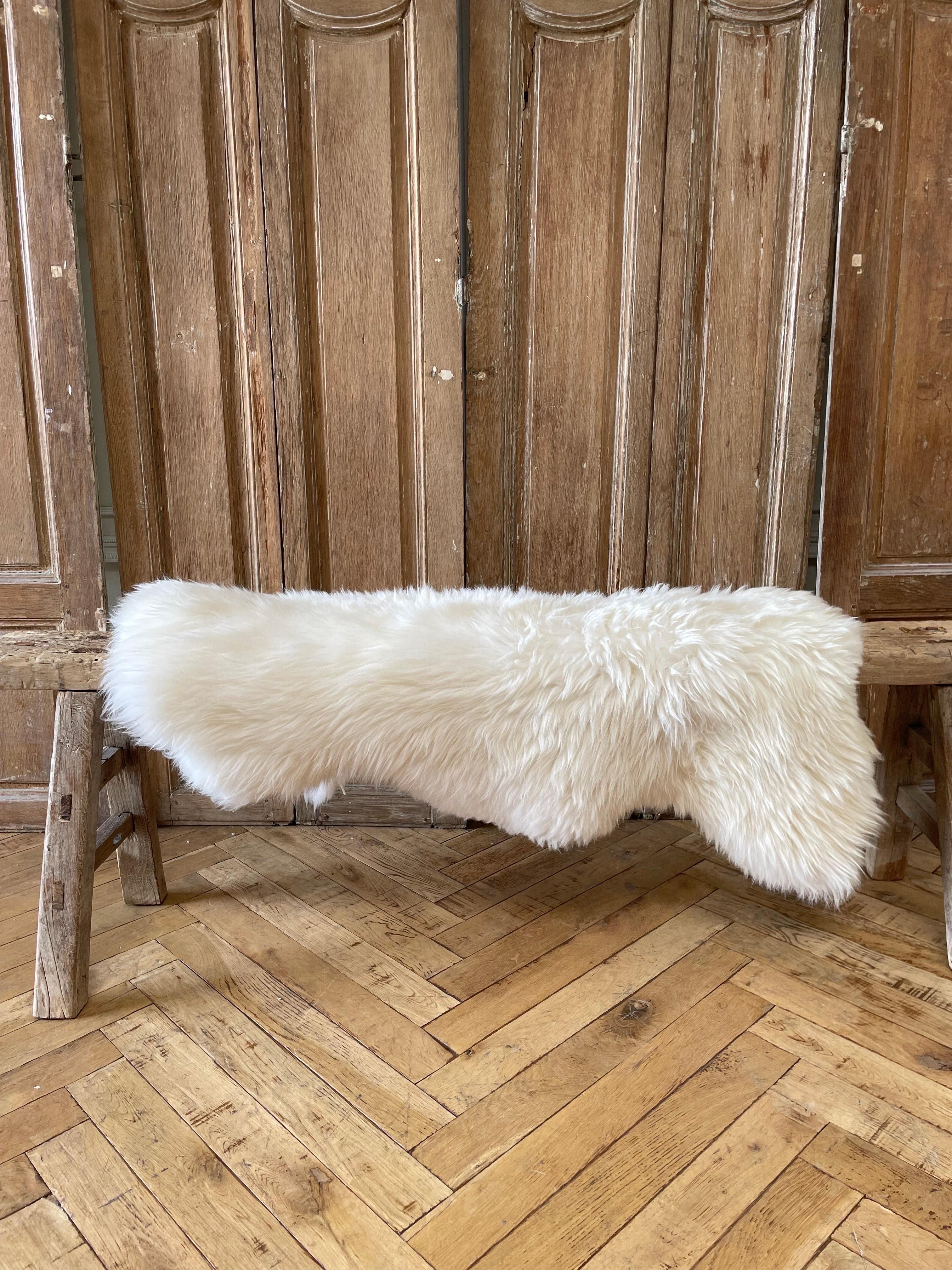 Natural Creamy white sheepskin
Long hair, use over a bench or as a rug.
Extremely soft to the touch. Dry Cleam. 
Origin: Paris France
Size: 40” x 32” / 27”
Center to center skin 36” x 25”.