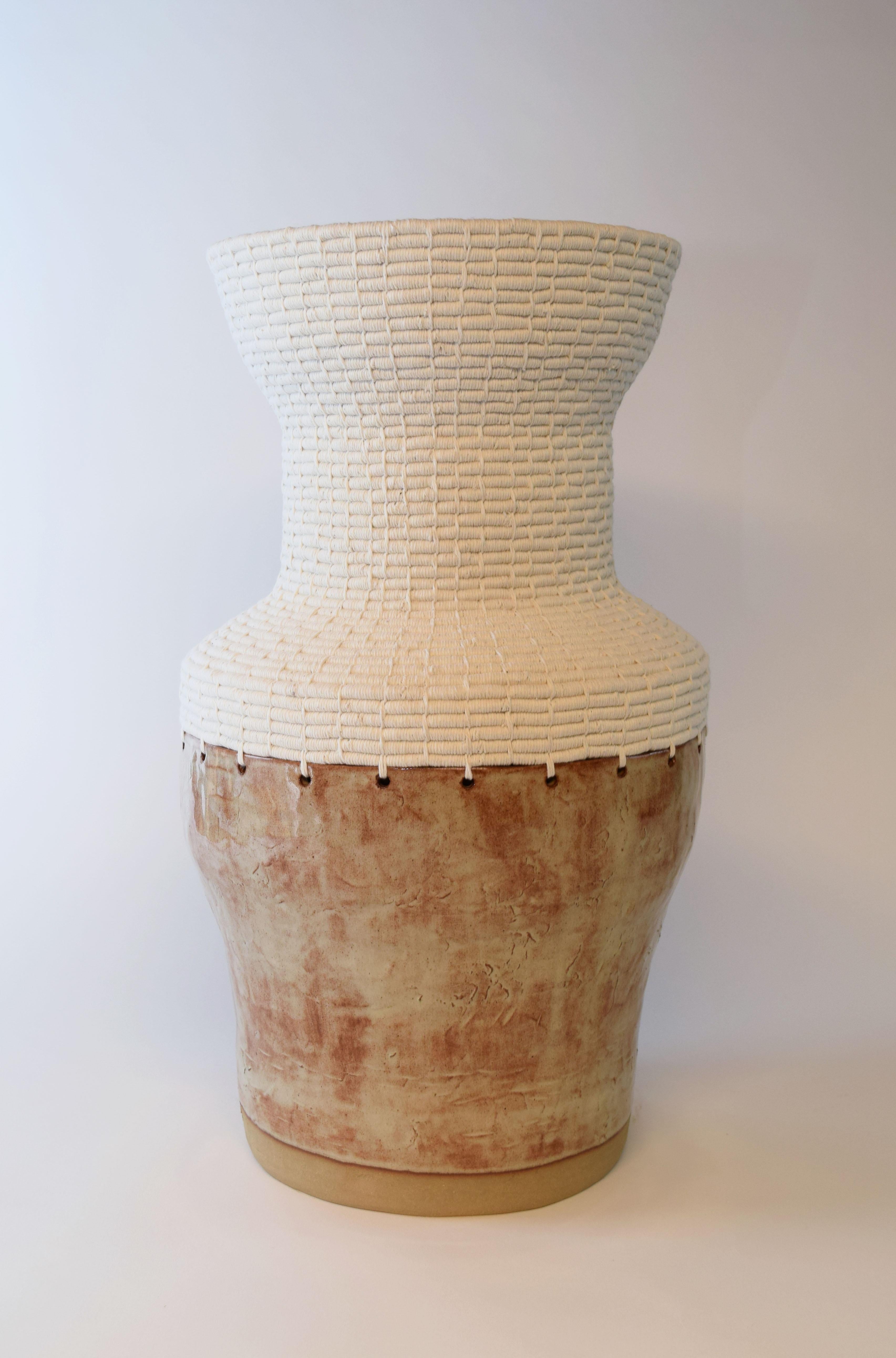 White Natural vessel by Karen Gayle Tinney
Dimensions: D 25.5 x W 25.5 x H 50 cm 
Material: Stoneware with cream, shino glaze, white cotton.

Karen Gayle Tinney is an artist and designer whose work consists of pieces that combine ceramic and