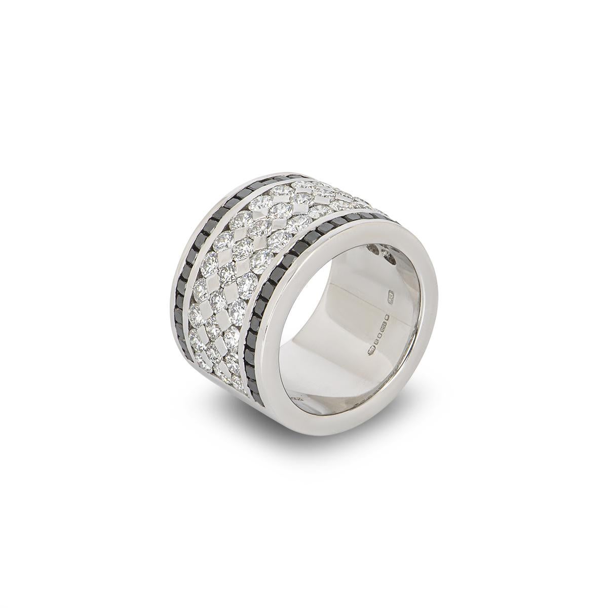 A stunning 18k white gold diamond band ring. The ring comprises of 42 round brilliant cut diamonds set across 3 rows in a tension setting, with a total diamond weight of approximately 1.40ct, G coloue VS clarity. Complimenting this is a row of