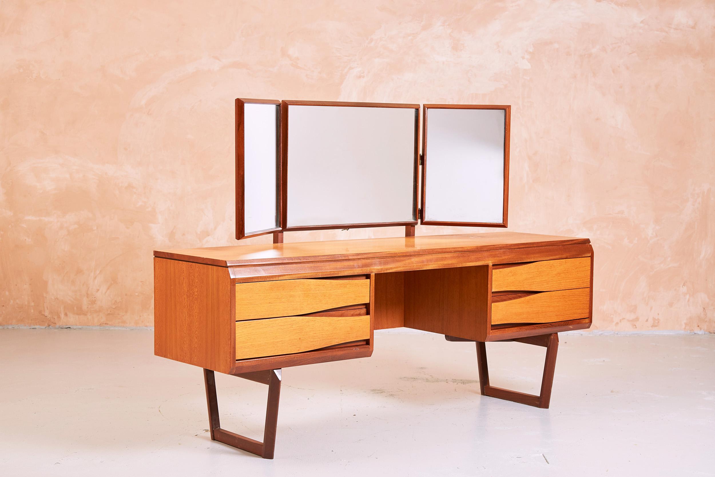 1960s dressing table by White & Newton of Portsmouth.

A scarcely seen model featuring contrasting teak and afromosia timbers, contoured drawers with recessed handles, and solid afromosia sleigh legs.

The dressing table is fitted with three