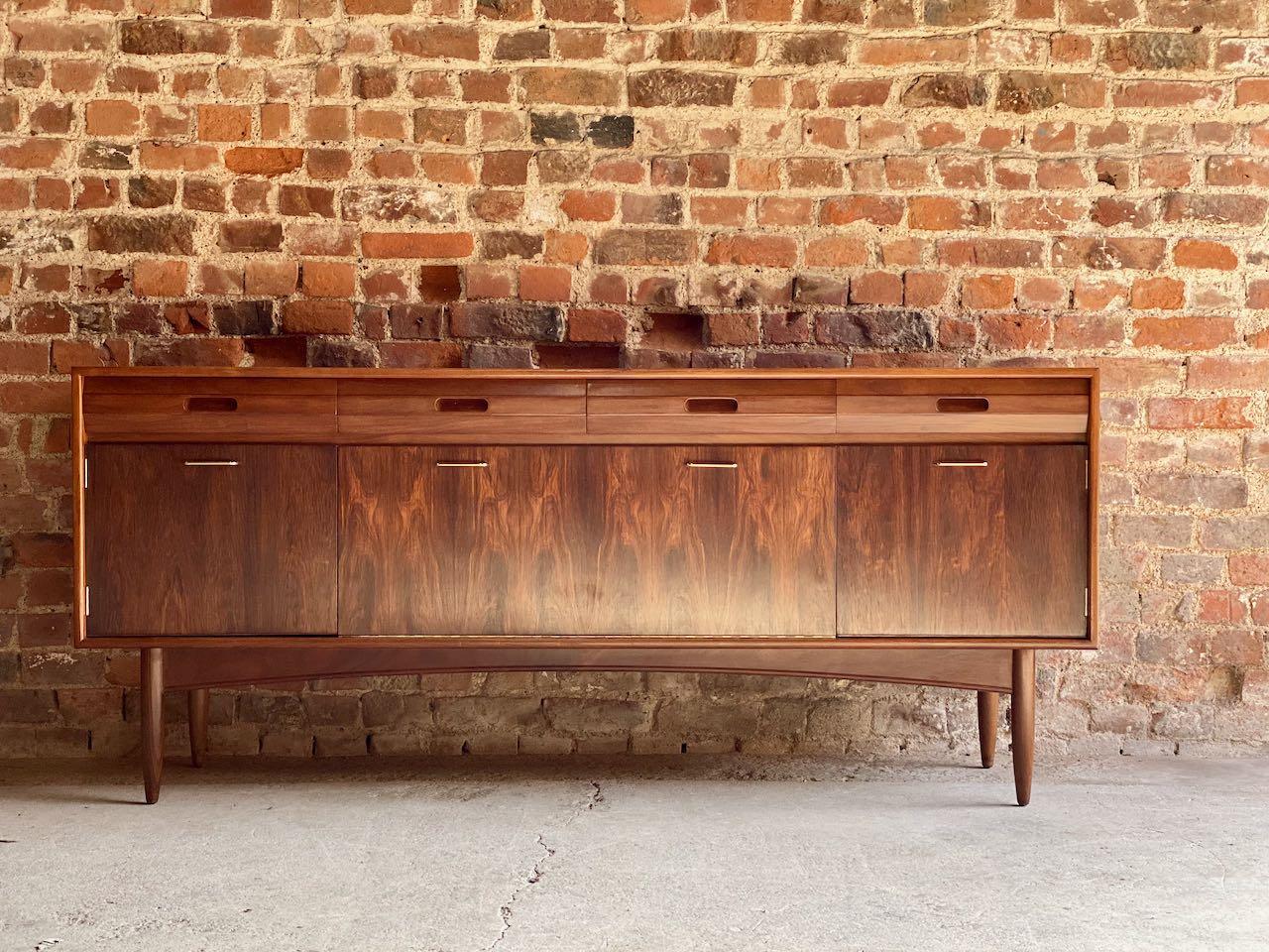 White & Newton of Portsmouth African Teak & Rosewood sideboard 1960s

Magnificent midcentury White & Newton of Portsmouth African teak (Afromosia) and rosewood sideboard credenza, made in the UK in the 1960s, the rectangular teak top over four