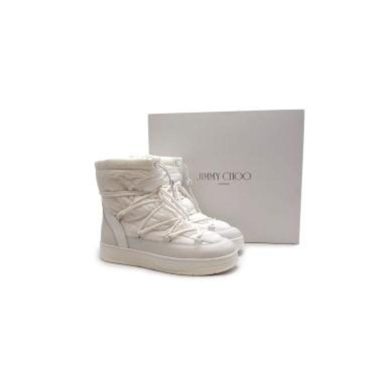 Jimmy Choo white nylon & leather Wanaka snow boots
 
 - Chunky, moon-boot style with jacqaurd nylon body and adjustable cord lacing 
 - Set on a chunky runner sole
 - Leather trims 
 
 Materials
 Nylon
 Leather
 Rubber
 
 Made in Italy 
 
 PLEASE