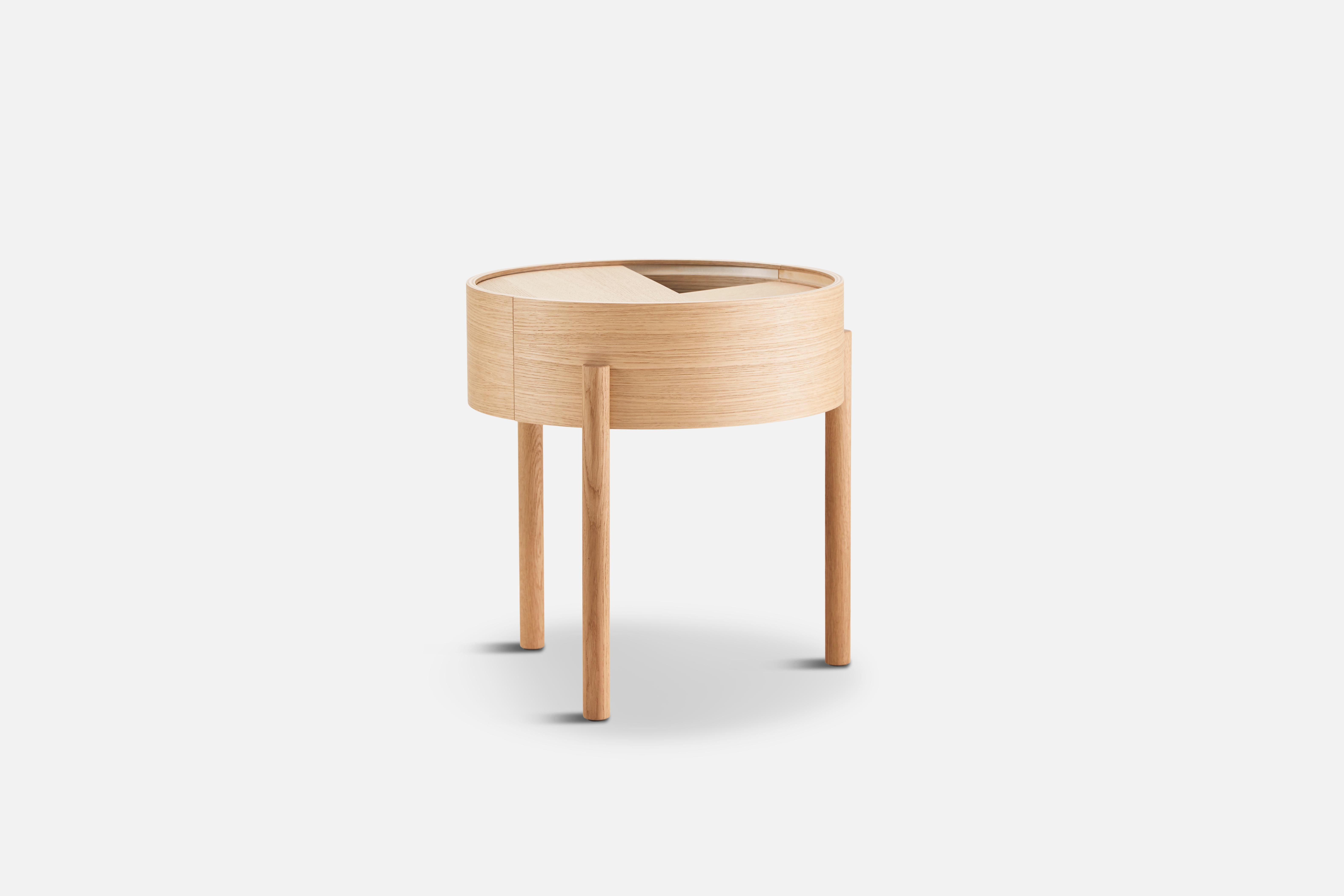 White oak arc side table by Ditte Vad and Julie Bertrup.
Materials: oak, lacquer. 
Dimensions: D 42 x W 42 x H 45 cm.

The founders, Mia and Torben Koed, decided to put their 30 years of experience into a new project. It was time for a change