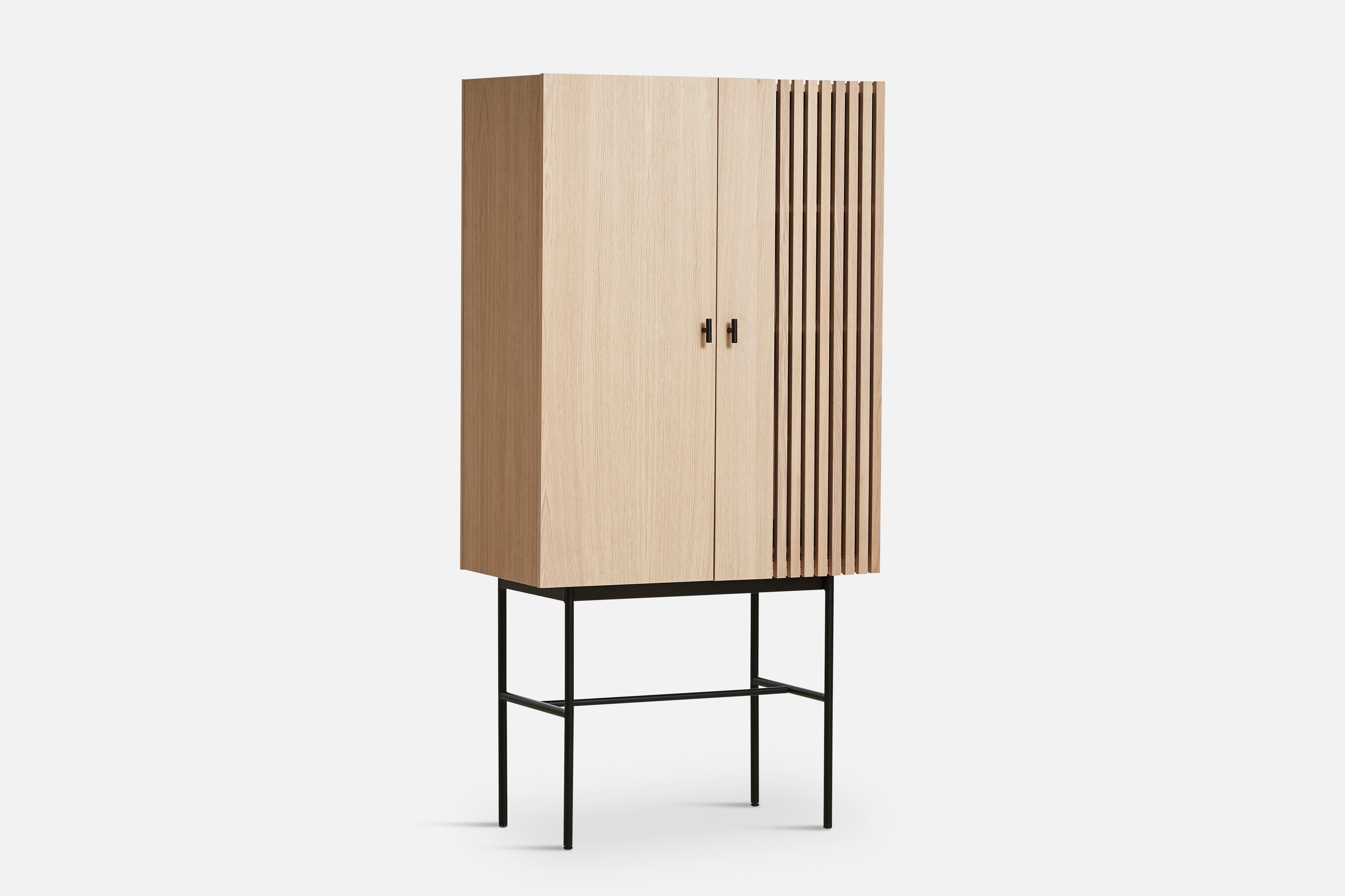 White oak array highboard 80 by Says Who
Materials: Oak, metal
Dimensions: D 44 x W 80 x H 160 cm
Also available in different colours and materials. 

The founders, Mia and Torben Koed, decided to put their 30 years of experience into a new