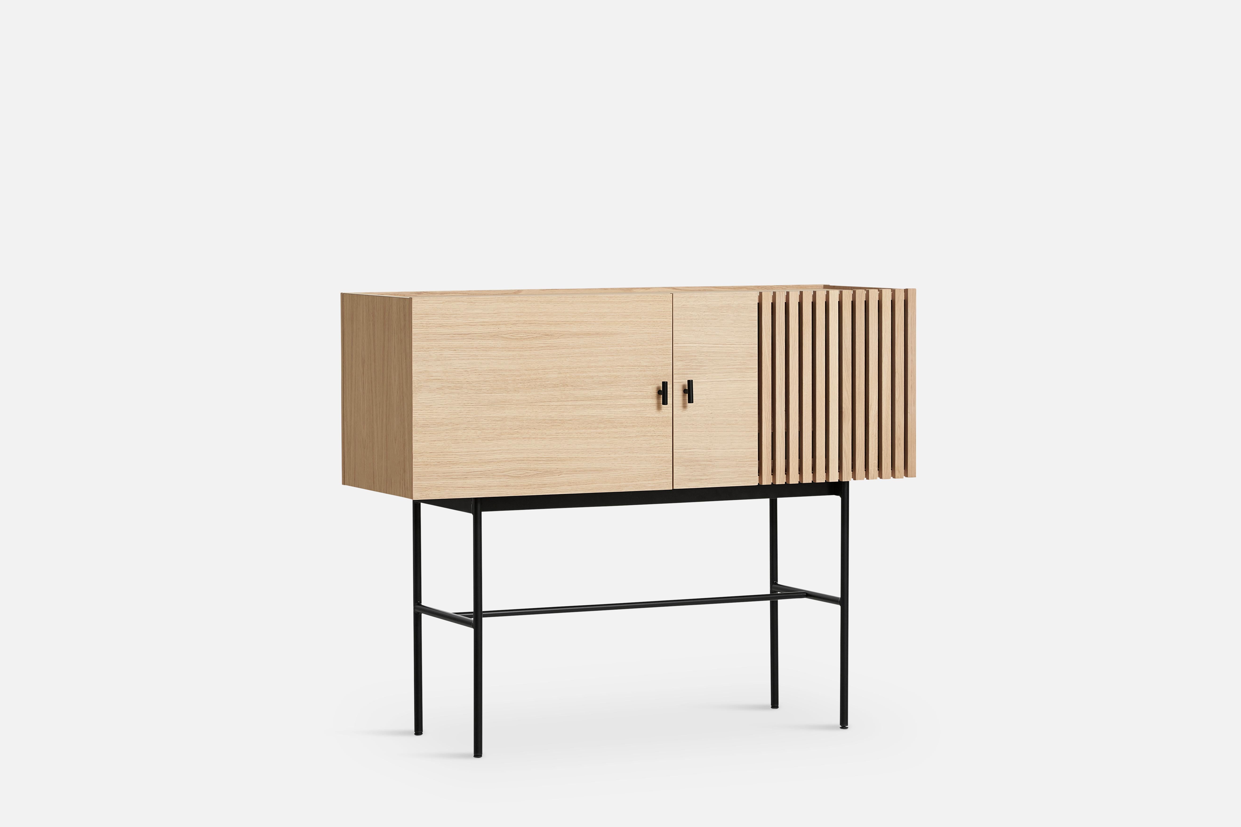 White Oak Array sideboard 120 by Says Who
Materials: Oak, Metal
Dimensions: D 44 x W 120 x H 97 cm
Also available in different colors and materials. 

The founders, Mia and Torben Koed, decided to put their 30 years of experience into a new