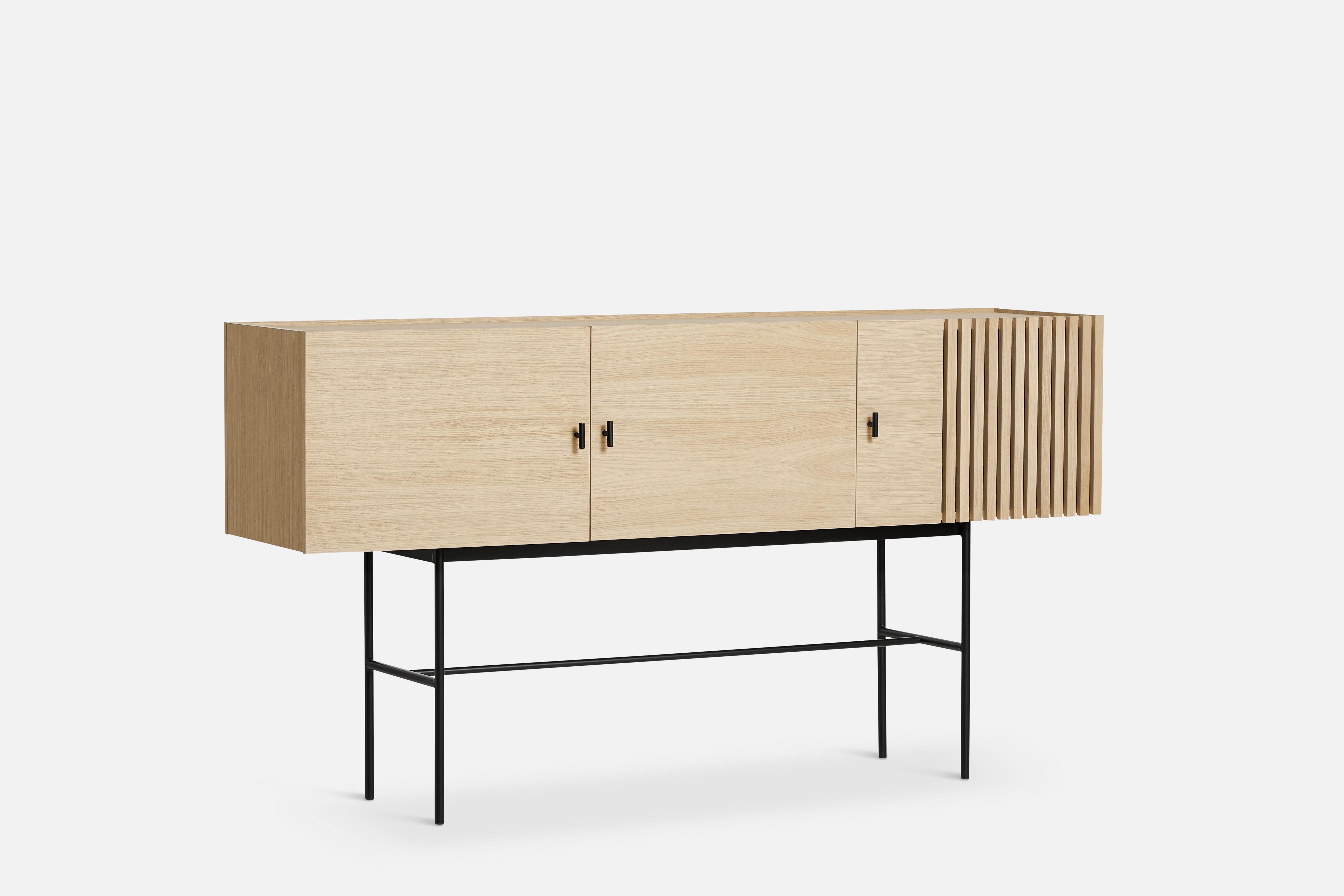 White oak array sideboard 180 by Says Who
Materials: Oak, metal
Dimensions: D 44 x W 180 x H 97 cm
Also available in different colours and materials. 

The founders, Mia and Torben Koed, decided to put their 30 years of experience into a new
