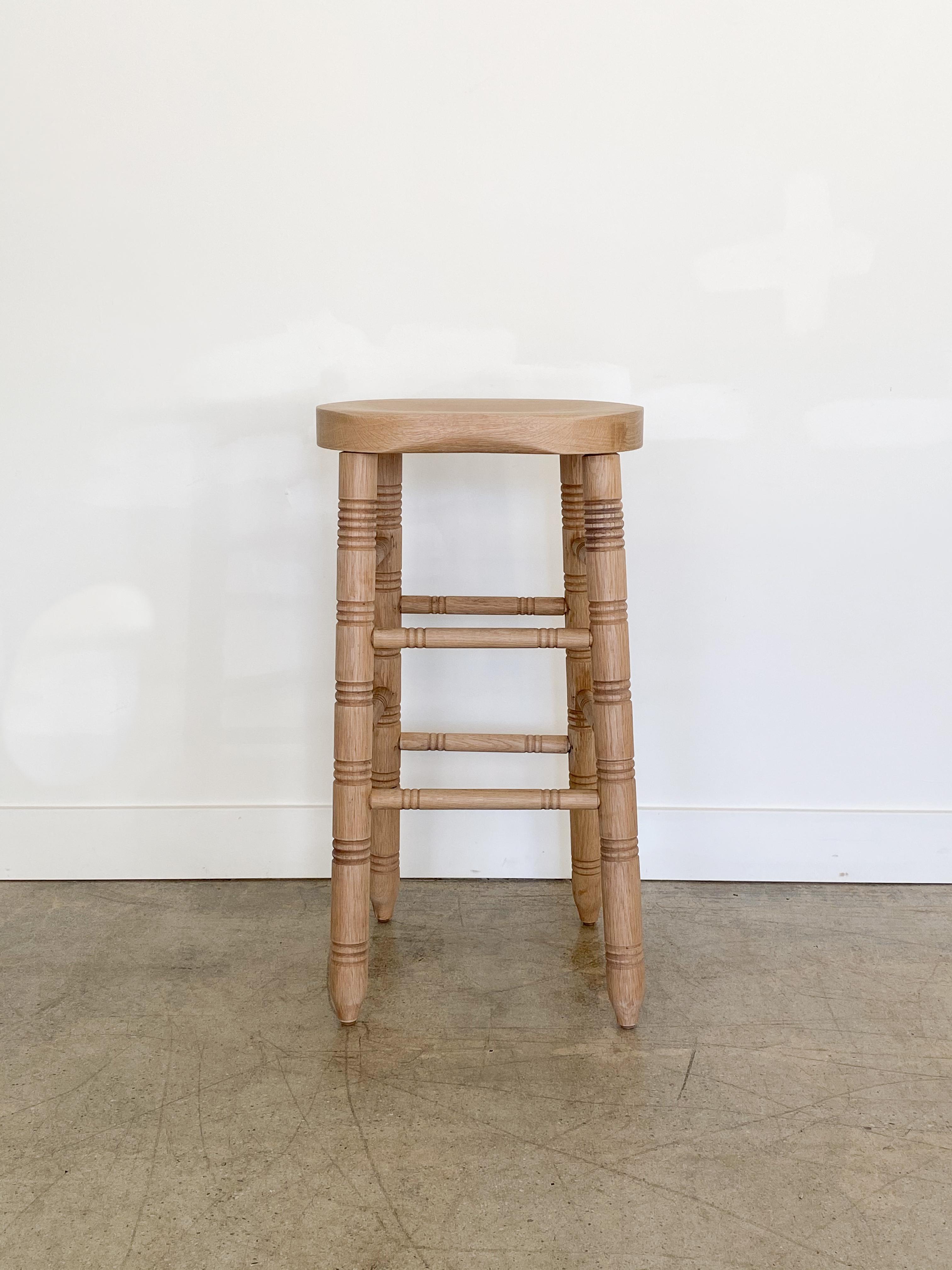 Newly made solid white oak bar stool with curved wood seat, four post legs and carved ring details. Natural oak finish. Made in Los Angeles. Multiple quantity and custom heights available.

  