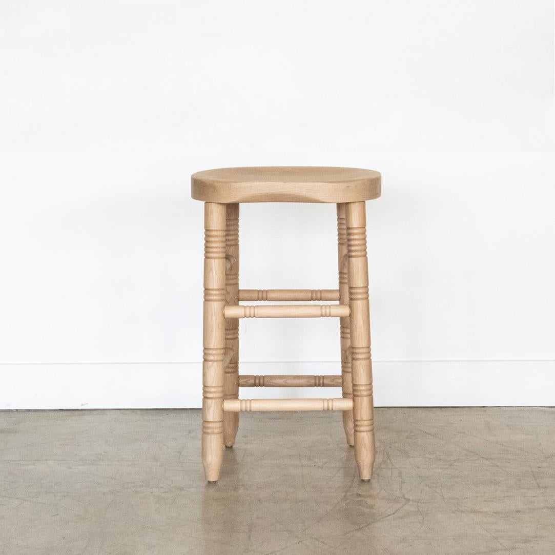 Newly made solid white oak counter stool with curved wood seat, four post legs and carved ring details. Natural white oak finish. Made in Los Angeles. Multiple quantity and custom heights available.

 
