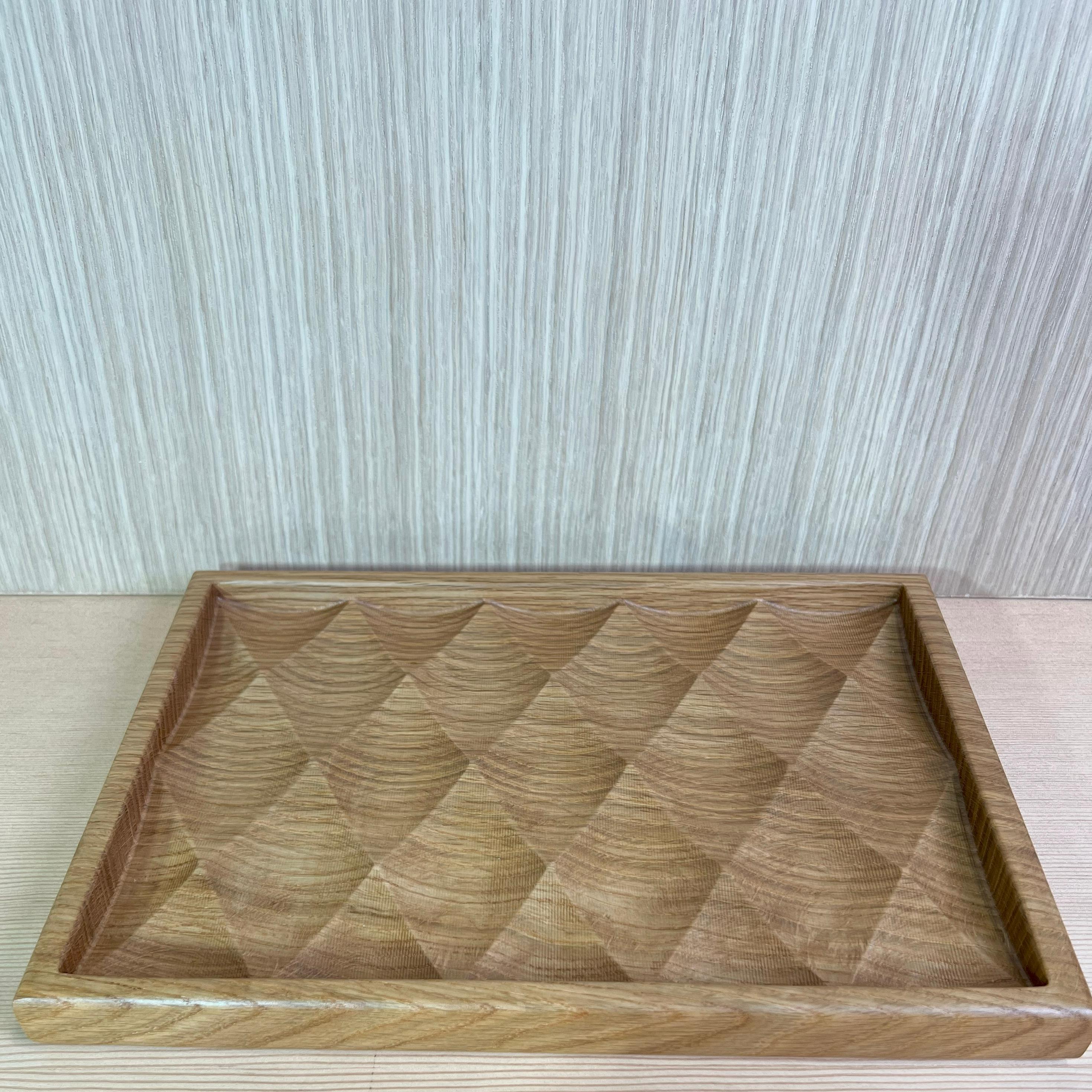 This elegant artisan tray made from top quality solid white oak wood. This piece was designed and created with extreme valleys and peaks to capture morning, afternoon and evening light. The lighting casts shadows and patterns that I have found