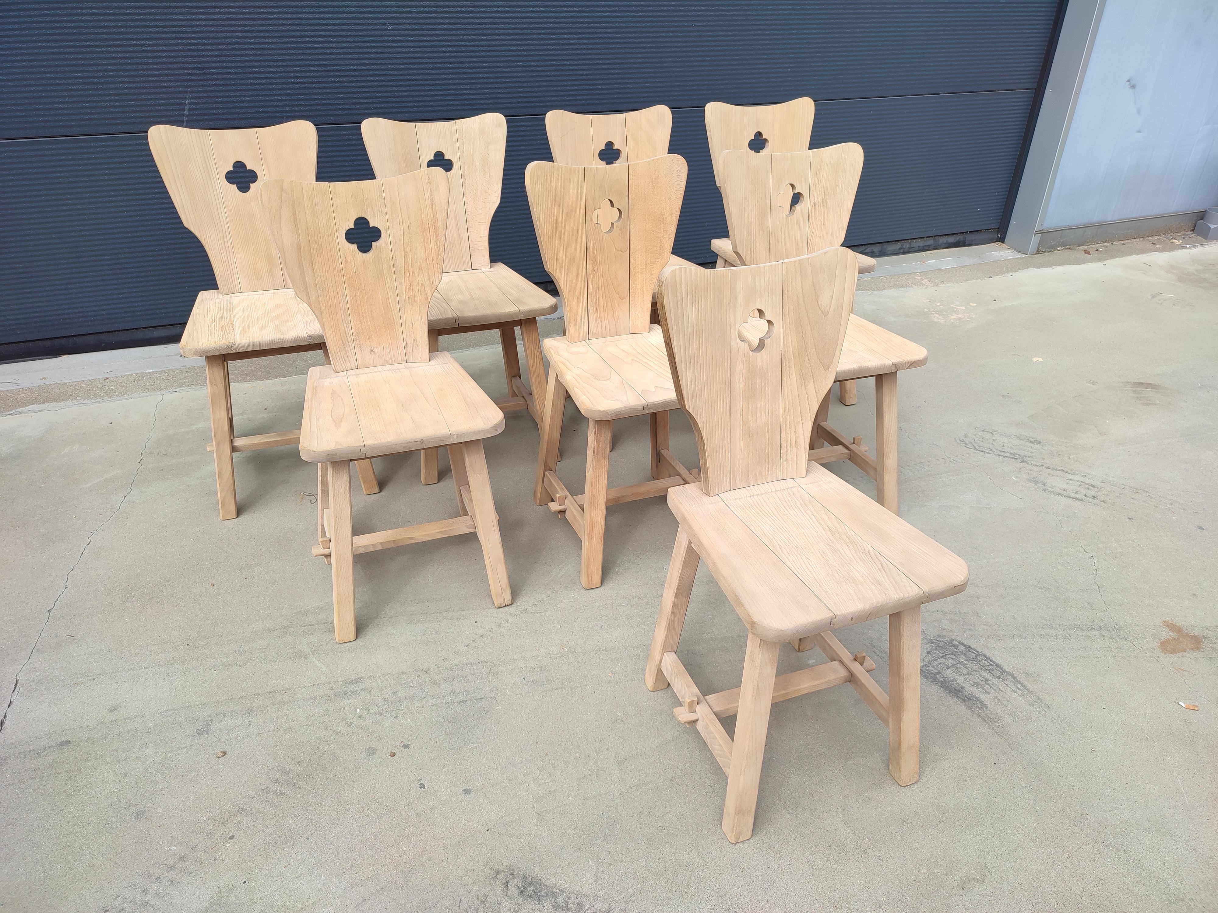 very elegant, bohemian oak natural chairs in a set of 8 made in france in the 1950s.