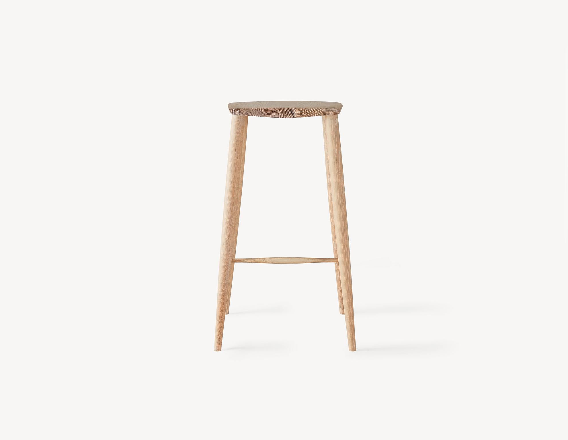 An instant Classic with a contemporary turned legs and a faceted top for comfort, this minimal counter height stool will stand the test of time and only get better with age. A light and durable stool that features wedged through-tenons as well as