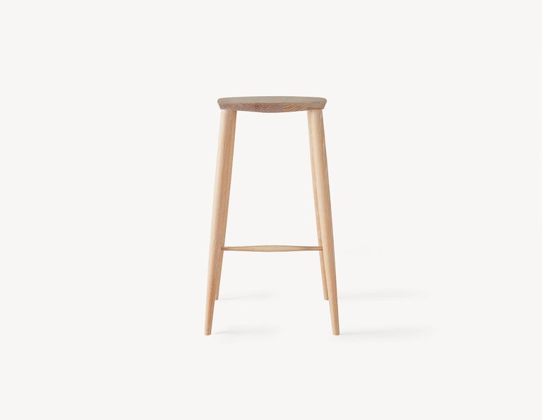 An instant Classic with a contemporary turned legs and a faceted top for comfort, this minimal counter height stool will Stand the test of time and only get better with age. A light and durable stool that features wedged through-tenons as well as