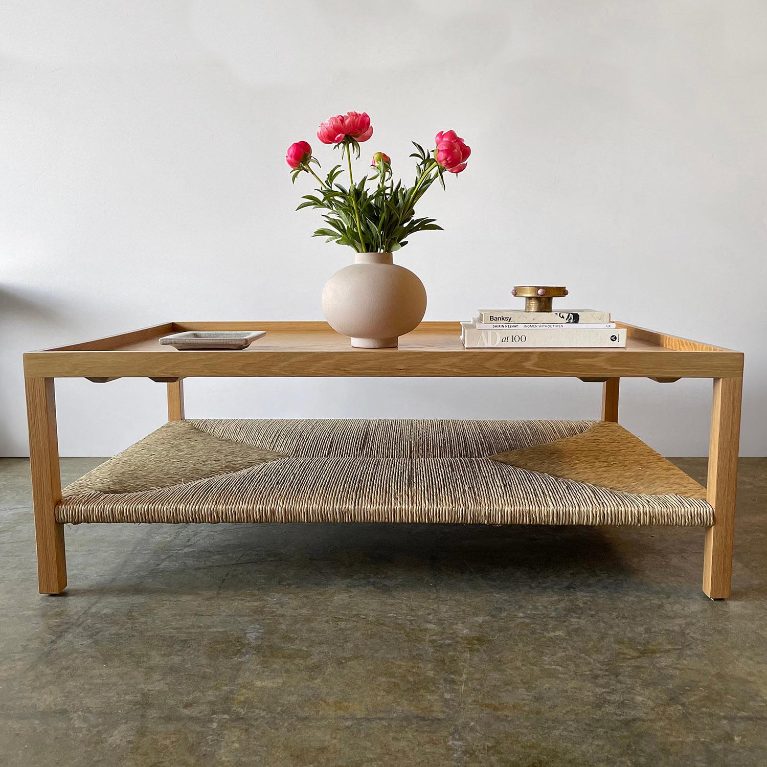 White oak & rush coffee table by Amber Interiors
Made of solid oak wood in a natural finish
Wonderful grain detail
Lipped edge 
Lower tier is handwoven rush 
Arcadia Coffee Table is a new production item
Made in Los Angeles by Amber Interiors