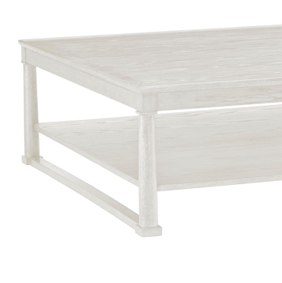 This elegantly designed piece combines functionality with style, making it the perfect centerpiece for any living room. Crafted from high-quality oak, the table white washed finish that highlights the natural grain and texture of the wood, adding