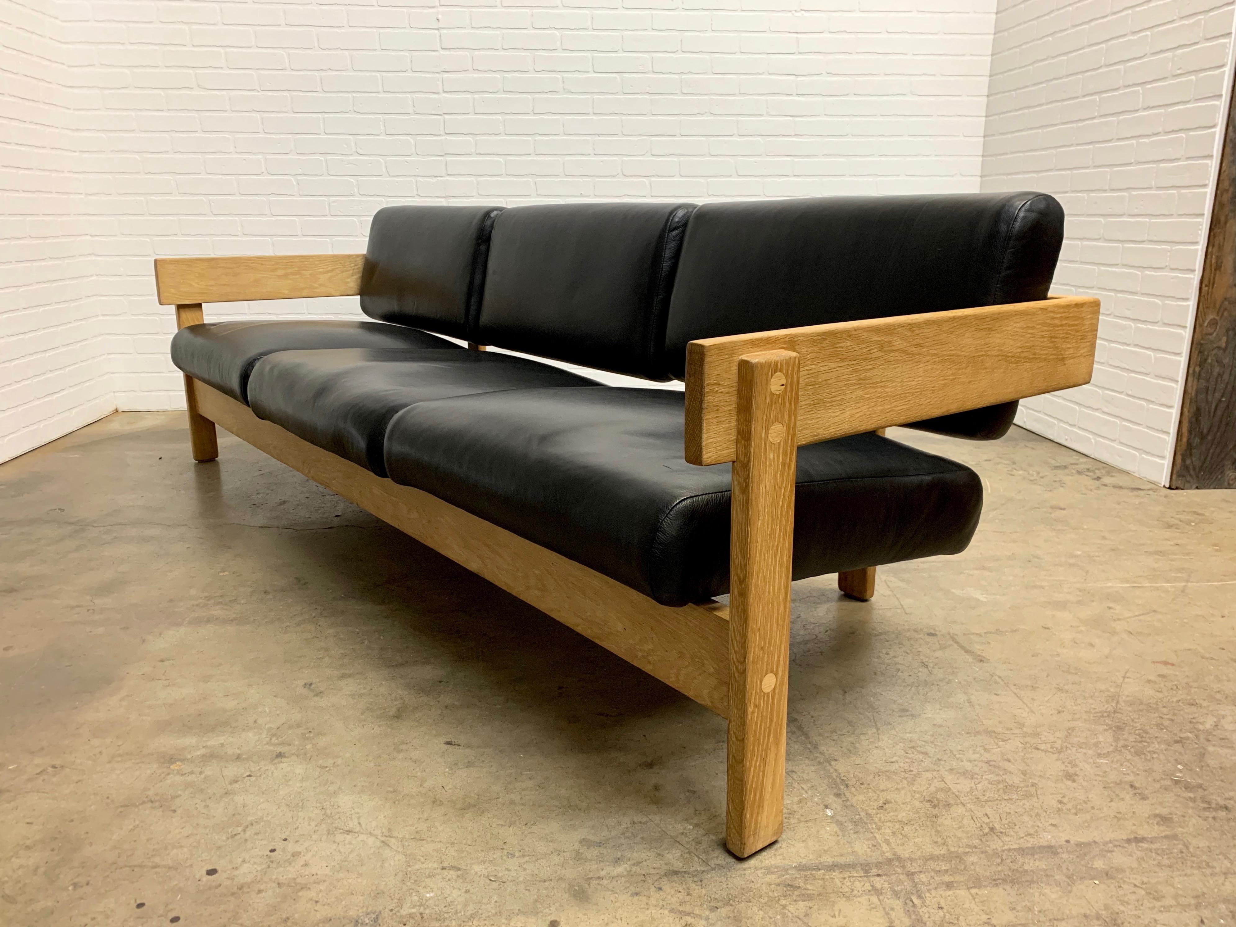 Raw white oak with supple black leather modernist sofa, very dramatic.