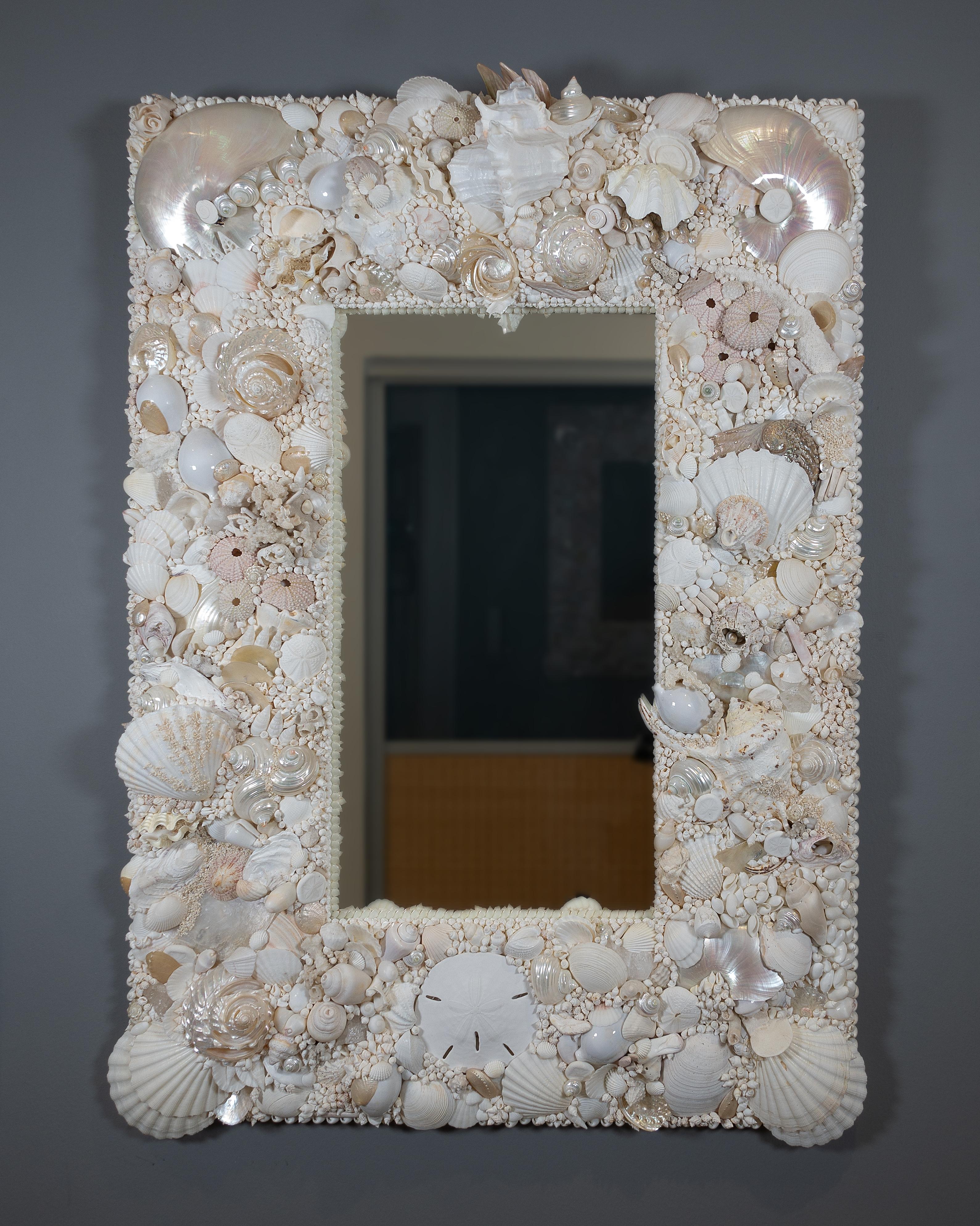 White Ocean – unique Shell Mirror by Shellman Scandinavia in Sweden.

An all-white shell mirror created in the Shellman organic free-form tradition. The frame is strikingly decorated with thousands of white and polished shells from near and far.