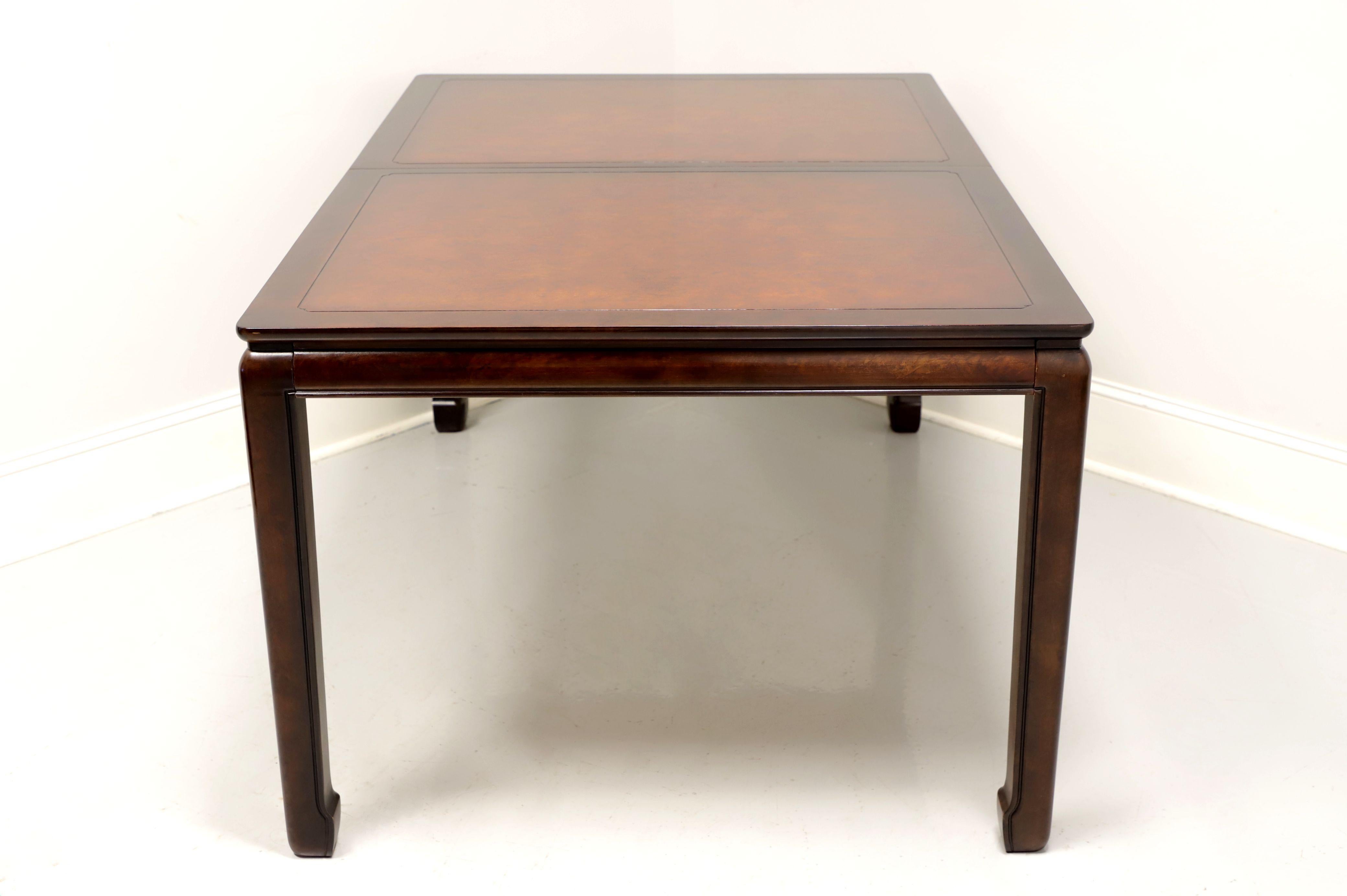 An Asian inspired rectangular dining table by White Furniture, of Mebane, North Carolina, USA. Solid mahogany with banded burl top, slender apron, Asian styled legs and feet. Metal expansion sliders. Includes two extension leaves. Made in the late