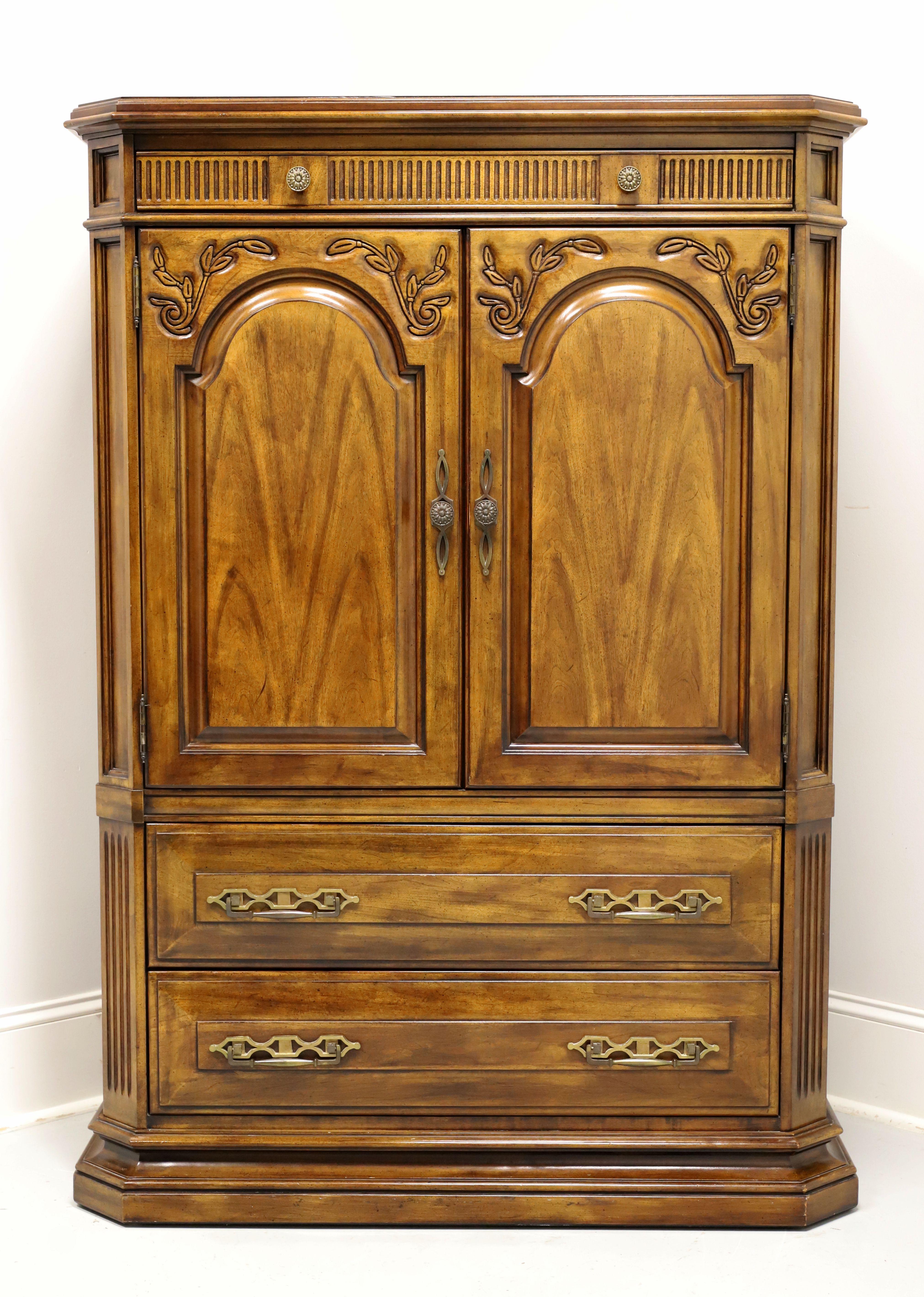 A French Country style gentleman's chest by White Furniture. Solid cherry wood with slightly distressed finish, ogee edge to the top, brass hardware, decoratively carved frieze over doors that conceals a hidden drawer, raised door & drawer fronts,