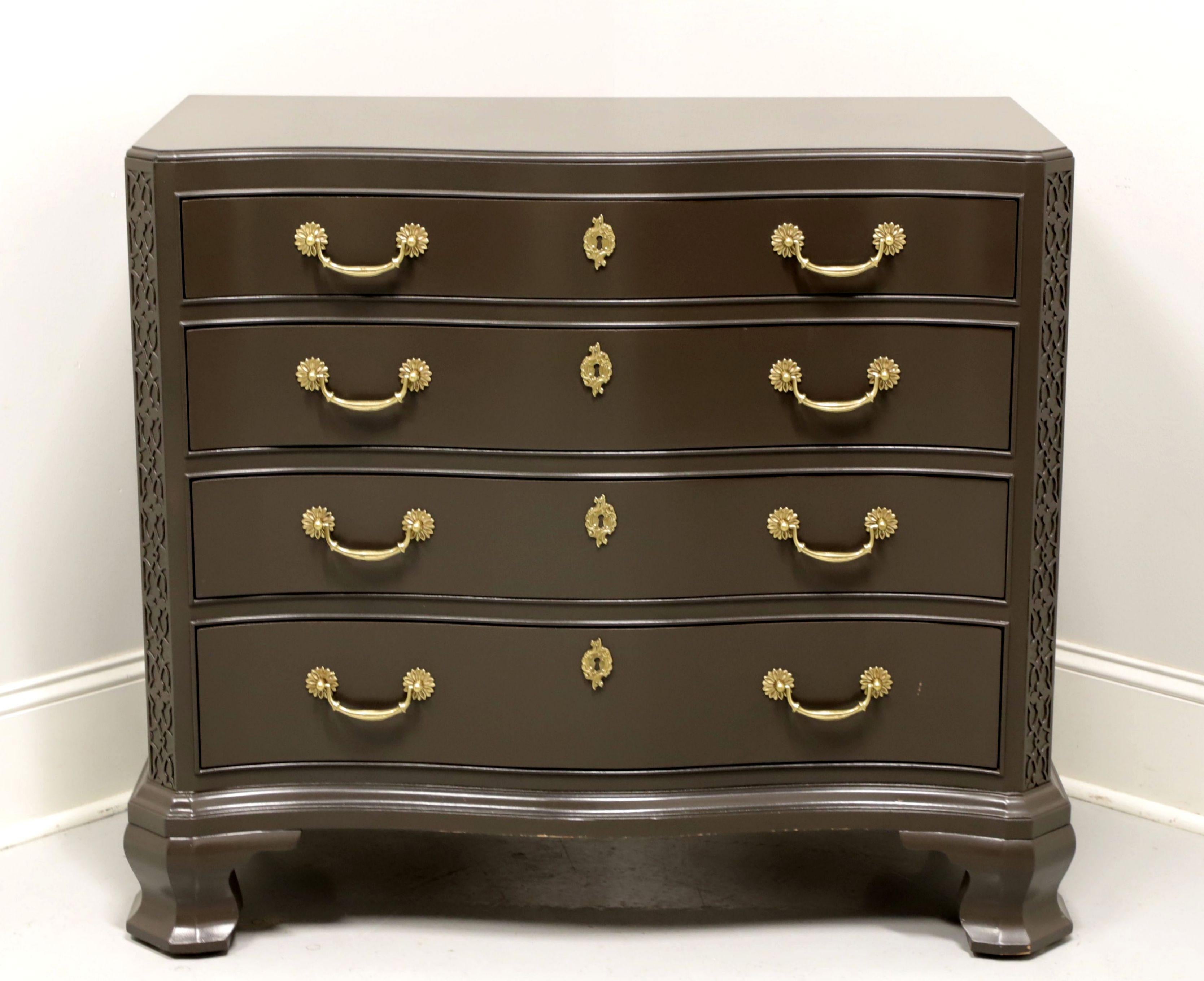A Chippendale style bachelor chest by White Furniture. Hardwood painted a soft gray color with brass hardware, serpentine front, canted corners with fretwork and ogee bracket feet. Features four various size drawers of dovetail construction with