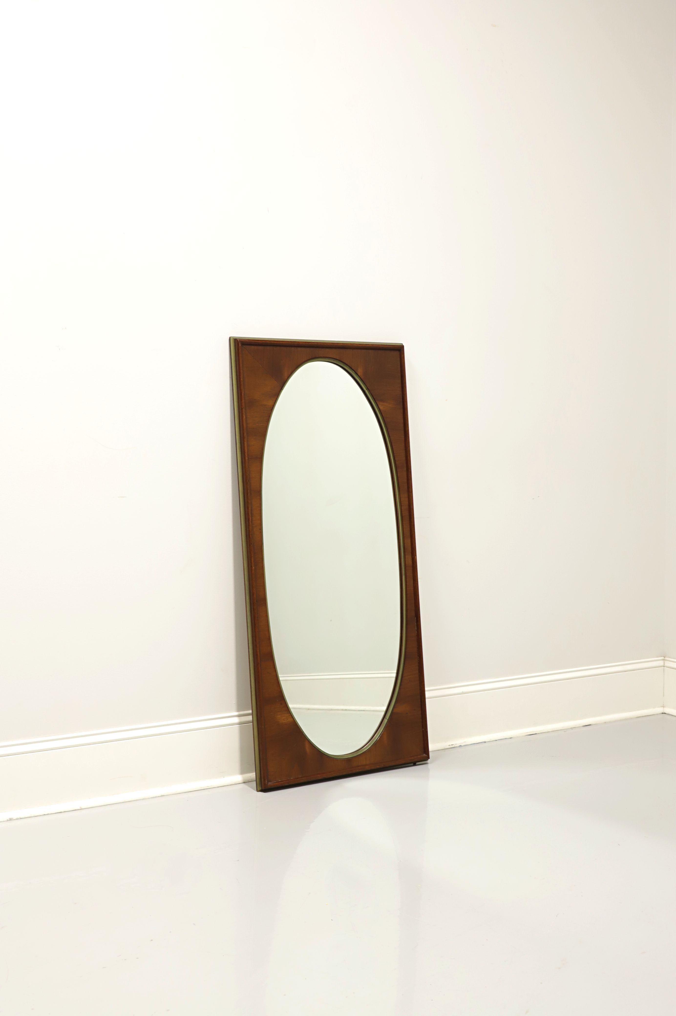 A mid century style wall mirror by White Furniture. Oval shaped mirrored glass and solid rectangular wood frame with their 