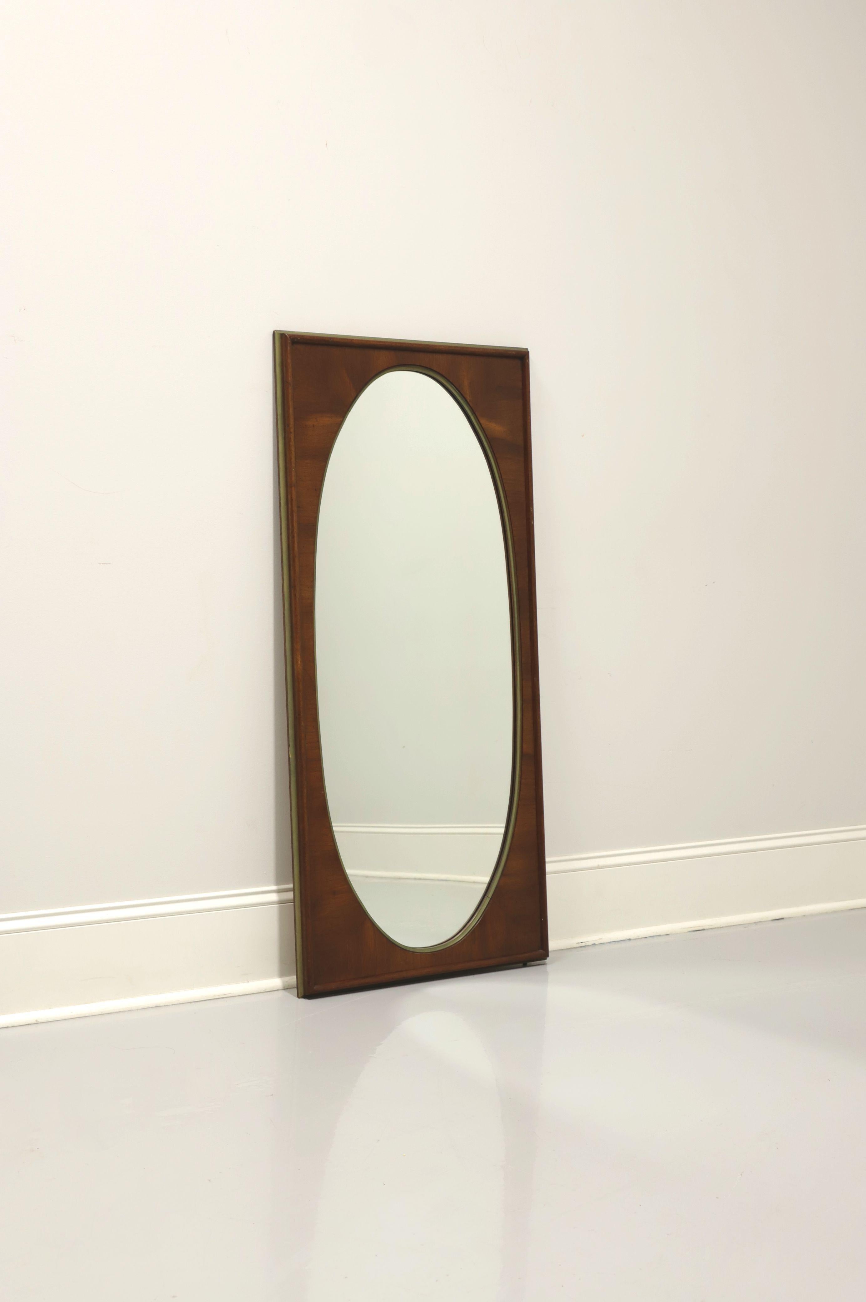 A mid century style wall mirror by White Furniture. Oval shaped mirrored glass and solid rectangular wood frame with their 