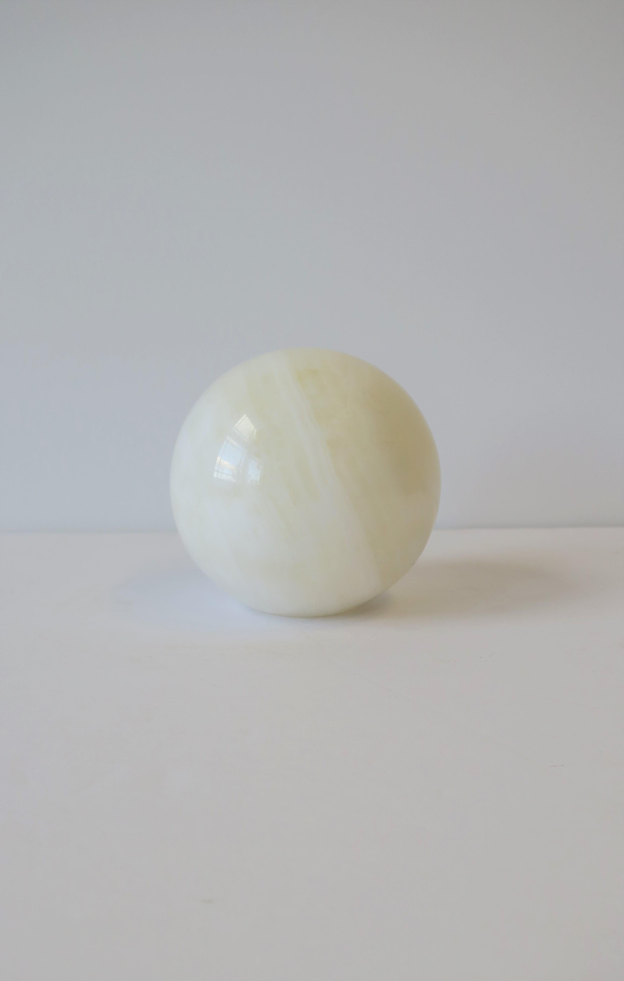 A substantial white onyx marble round ball sphere decorative. Piece has flat bottom for stability. A great decorative object for a living room, office, etc. Dimensions: 3.5