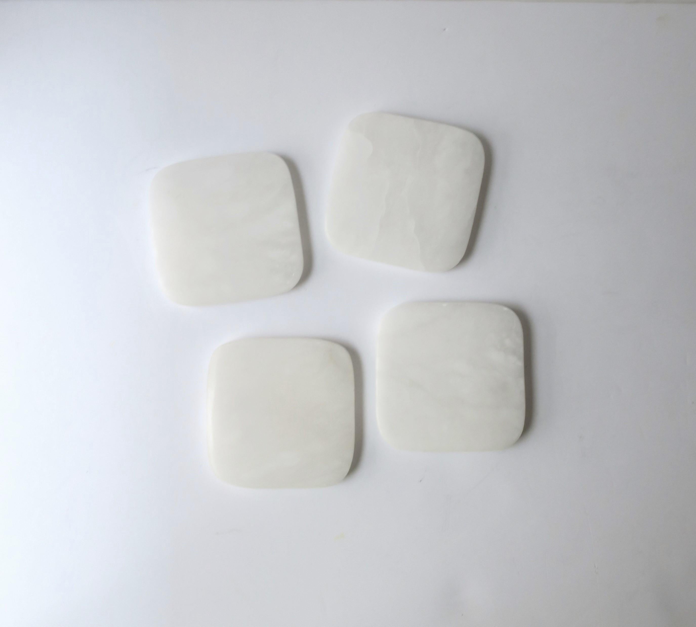 A set of four (4) white onyx marble cocktail drinks coasters, in the modern style. A great set with soft round corners and protective white felt on bottom. Perfect for drinks, cocktails, champagne, etc. A great addition to any bar or bar cart, and a