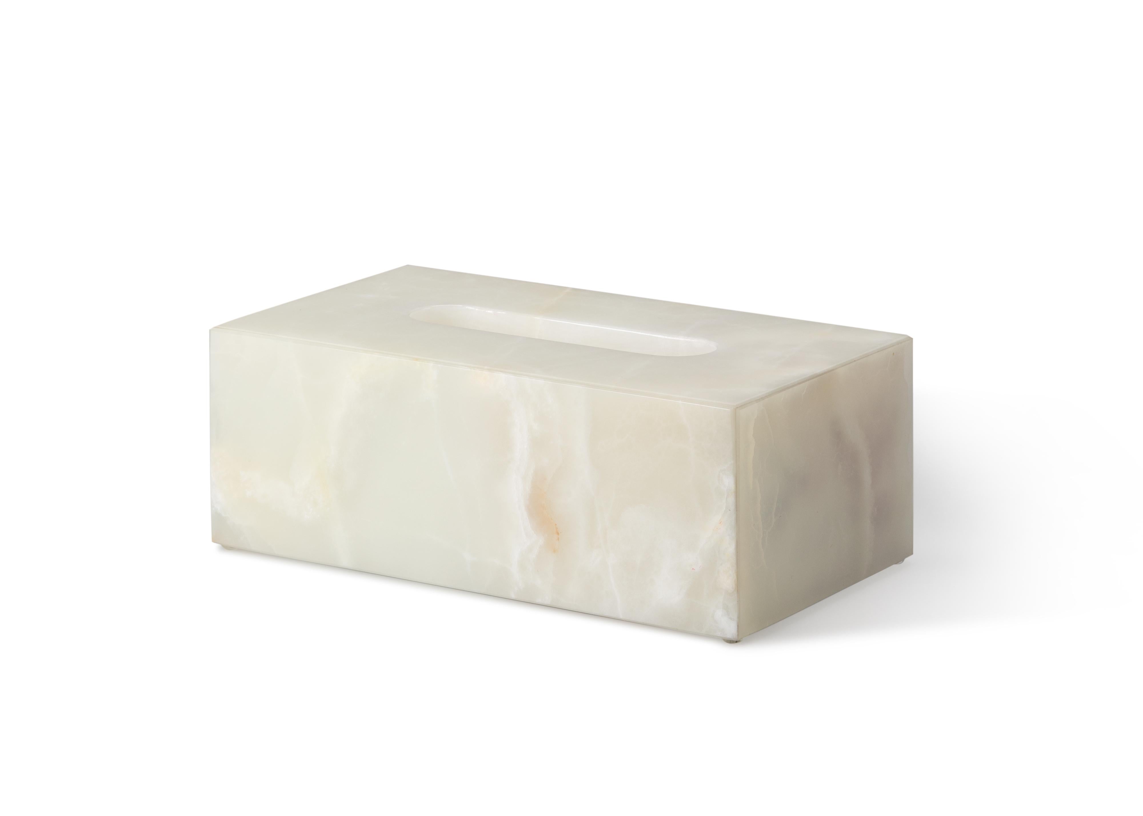Crafted entirely by hand, this onyx tissue box cover is a fusion of form and function, seamlessly blending into any space while adding sophistication and elegance. Clean, minimalist lines highlight the natural veining of the marble, making each