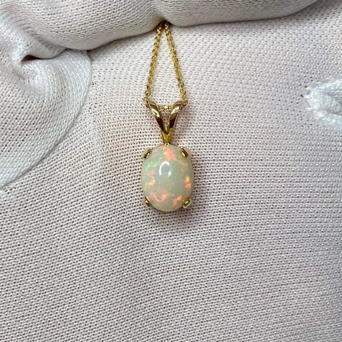 Beautiful white opal with stunning play of colour set in a fine 14k yellow gold solitaire pendant.

Stunning Welo opal with an excellent polish and lots of colour flash. Blues, greens, oranges, yellow, purple, reds... this stone is filled with