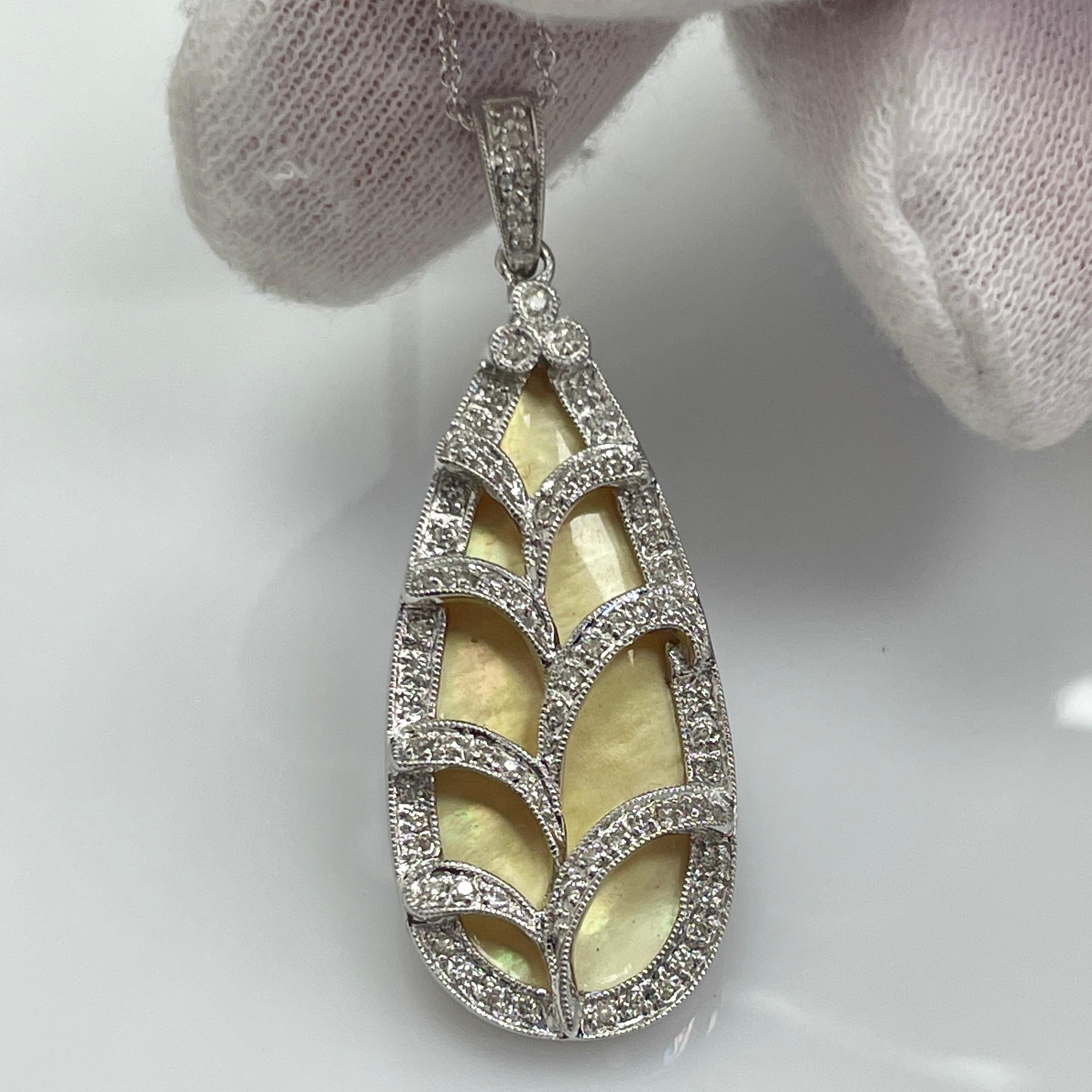 A lively white pear shape opal 18K white gold pendant with .30Ct of brilliant white diamonds.