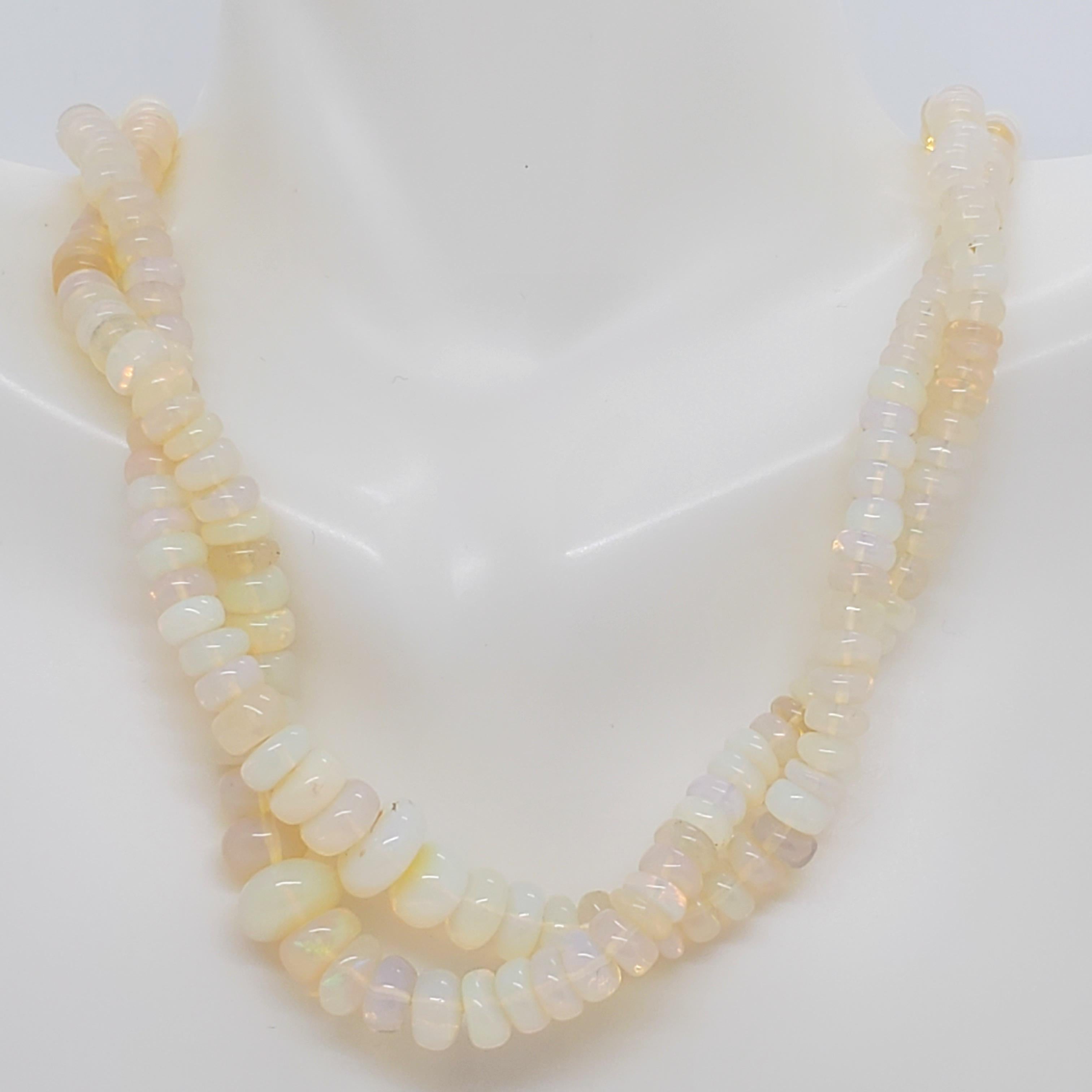Beautiful necklace with 2 strands of white opal beads and a very nice 18k yellow gold clasp that has 0.15 ct. white diamond rounds.  Length is 16