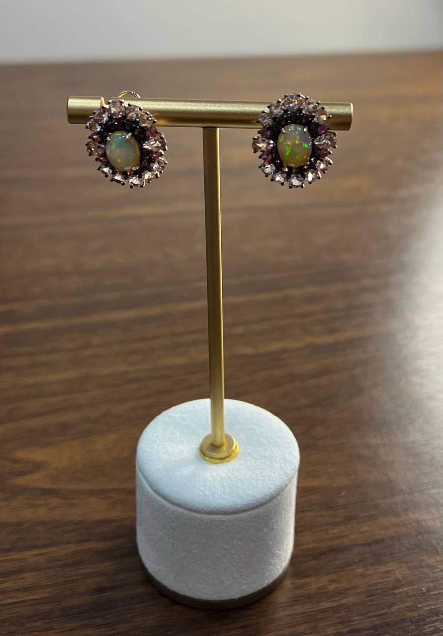 The opals exhibit a captivating play of color, making them a perfect choice for any sophisticated event or evening affair. With Brown diamonds and morganites, in 18K Rose Gold.

Intricate, refined, and timeless.