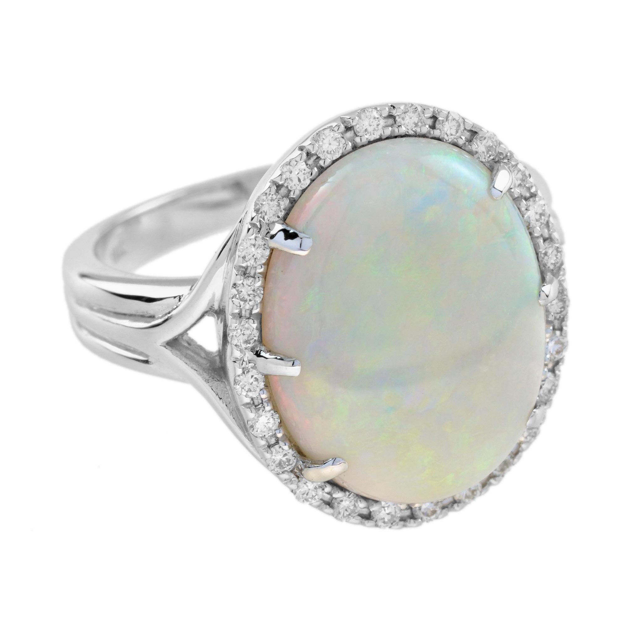 This beautiful ring is a classic vintage inspired style, the halo ring features play-of-color oval 4.22 carat opal for its center, surrounded by twenty-six white diamonds. This would make a wonderful statement ring, or just because it is