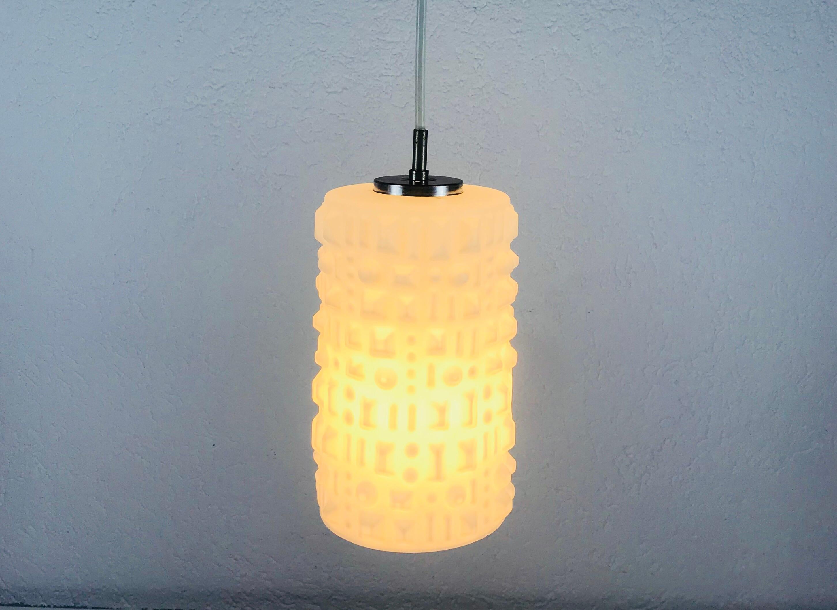 A Peill and Putzler hanging lamp made in Germany in the 1970s. It is fascinating with its glass ornaments. Textured opaline glass with aluminium top.

Measurements:

Height: 67 cm

Diameter: 13 cm

The light requires one E14 light bulb.