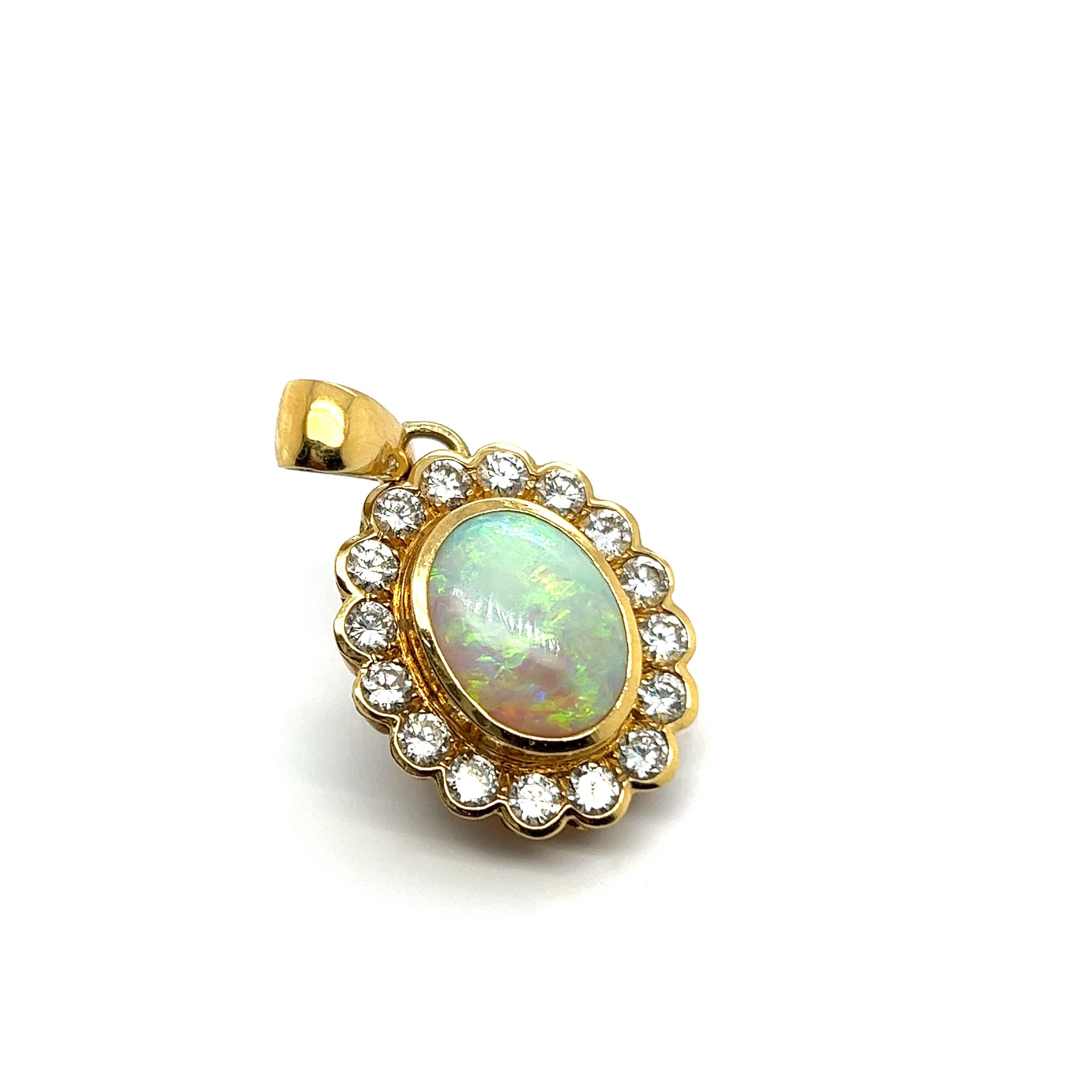Presenting a white opal pendant in 18 Karat yellow gold is a luxurious and elegant piece of jewelry. 

The opal, with its milky white body tone, highlights a mesmerizing play-of-color with vibrant flashes of gold, green, blue, and violet. The opal