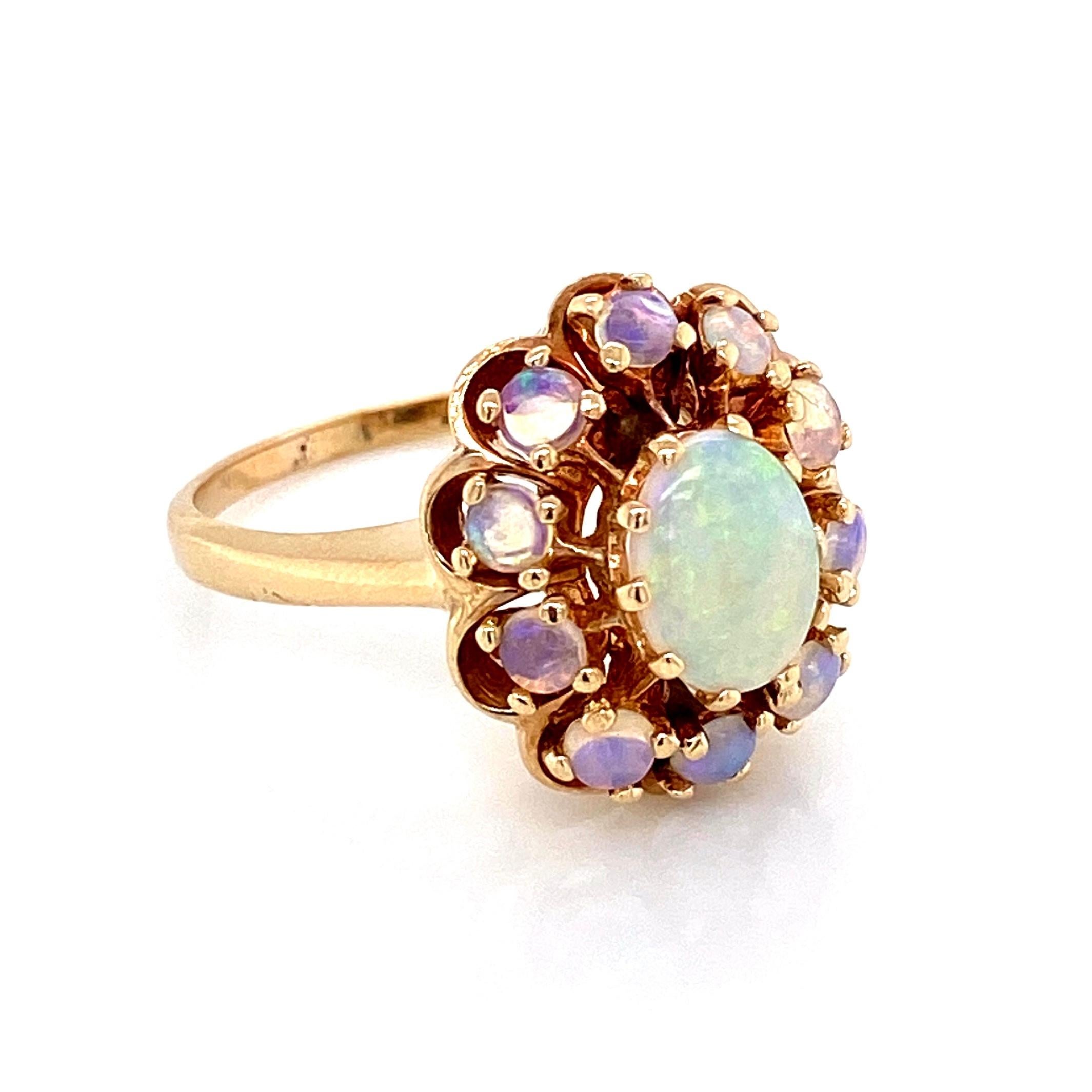 Simply Beautiful Victorian Style White Opal Gold Cocktail Cluster Ring, center securely set with a Fine White Opal Gemstone of oval form and surrounded by 10 round Opal gemstones. 1.5 total Carat weight. Hand crafted in 14 Karat yellow Gold.